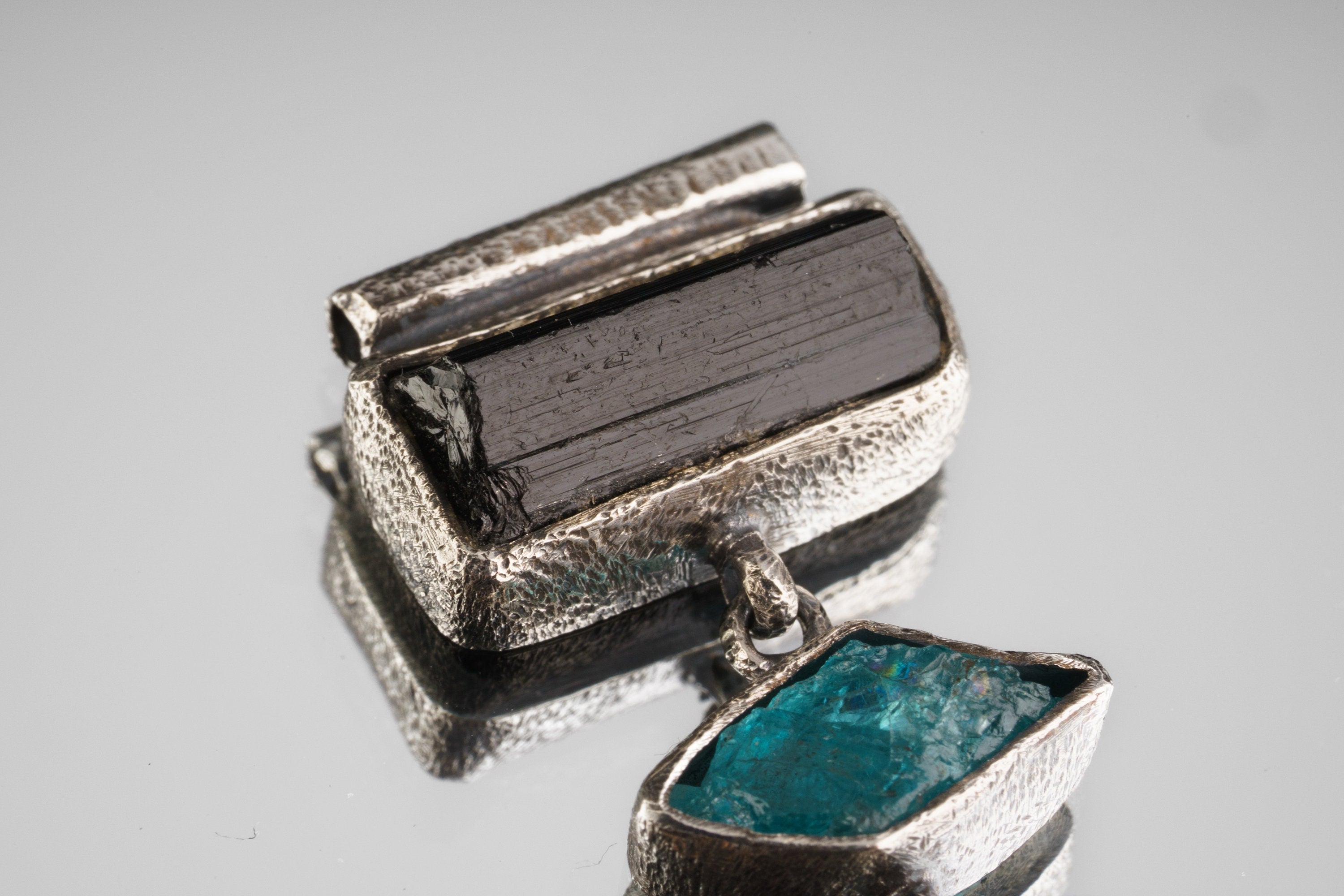 Close-up of Black Tourmaline, Blue Apatite, and Labradorite set in oxidized sterling silver with raw textured detail.