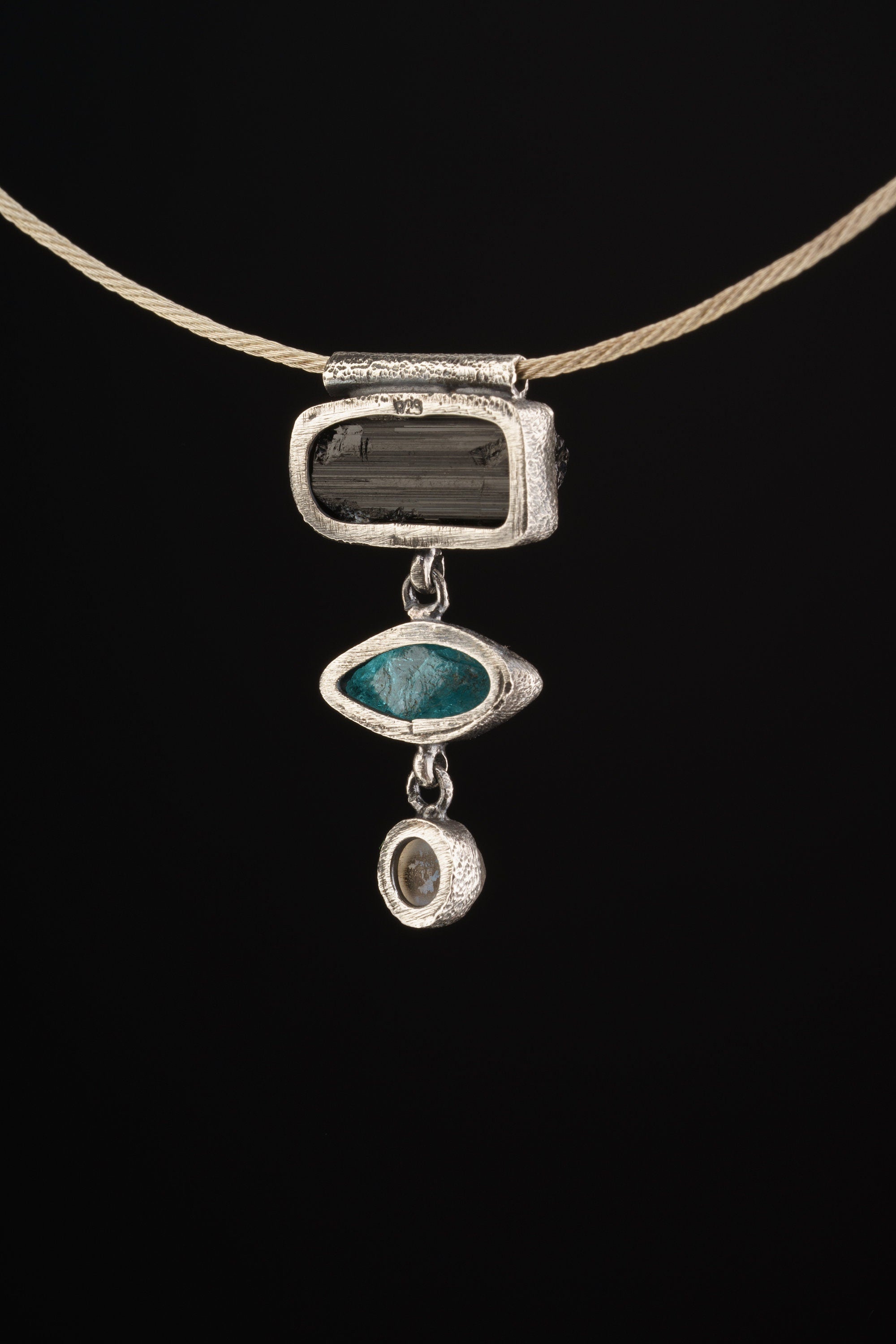Grounding Vision Stack Pendant shown on black cord with vertical stone arrangement and compact oxidized silver setting.