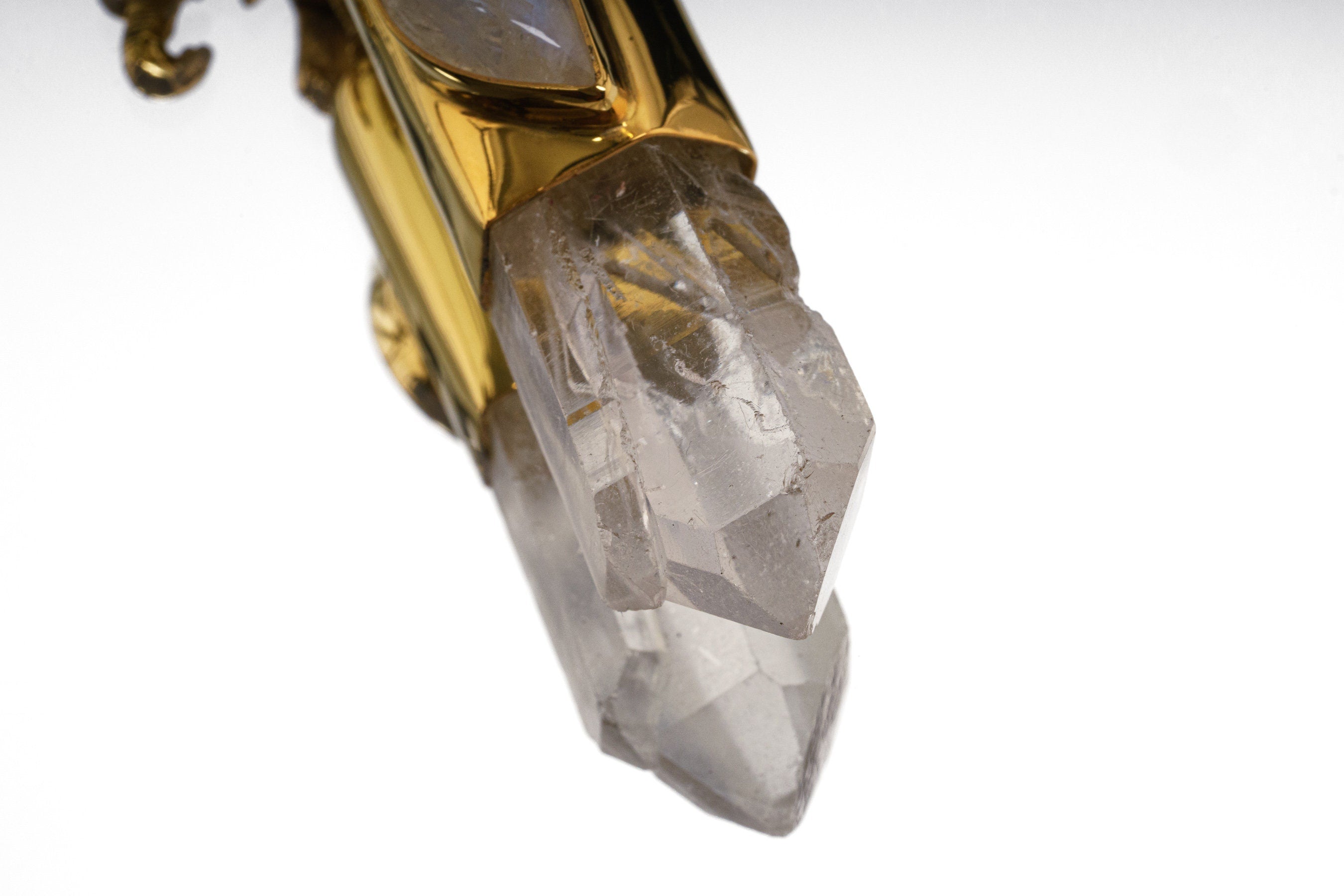 Close-up of Clear Quartz crystal point in an Elephant Moonstone talisman pendant with handmade silver detail.
