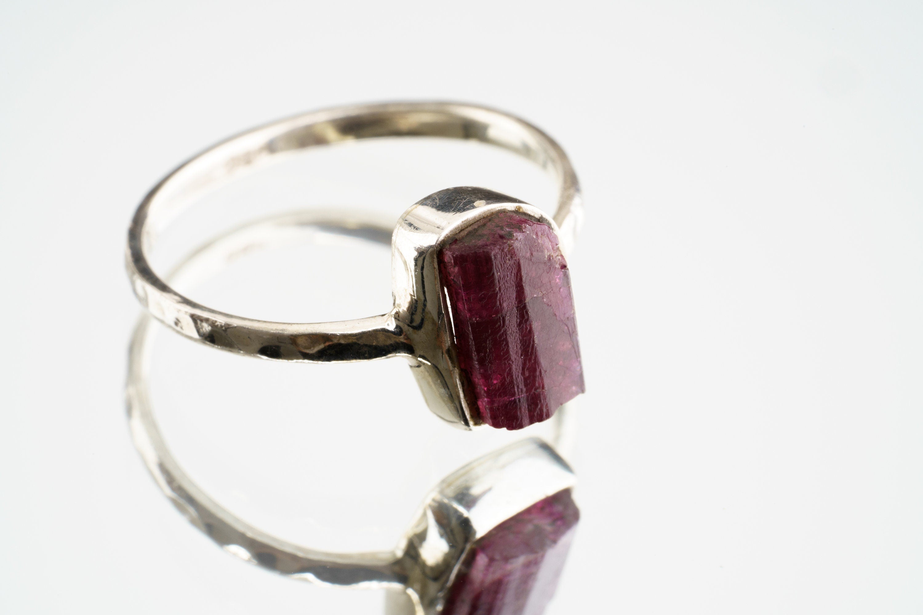 Pink Tourmaline sterling silver ring shown on a light background, with a rose gemstone and handmade silver setting.