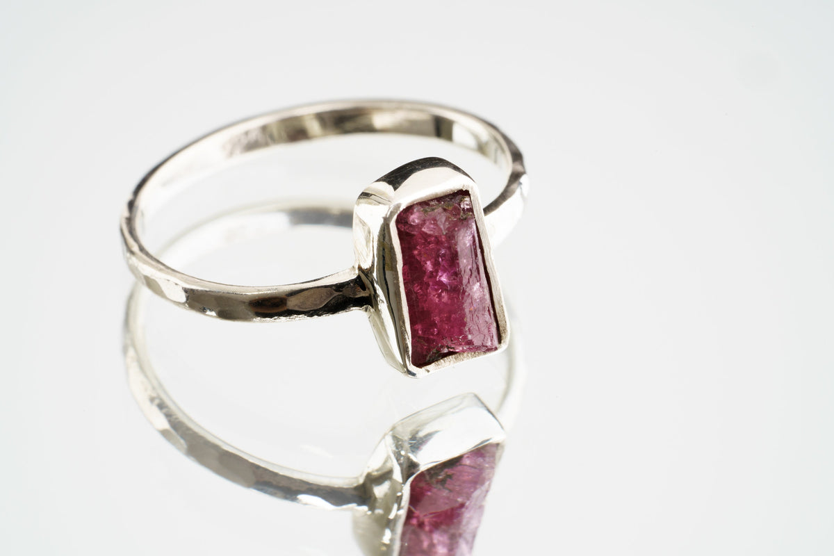 Handmade 925 sterling silver Pink Tourmaline ring shown worn on the hand, with a deep rose gemstone and solid silver band.