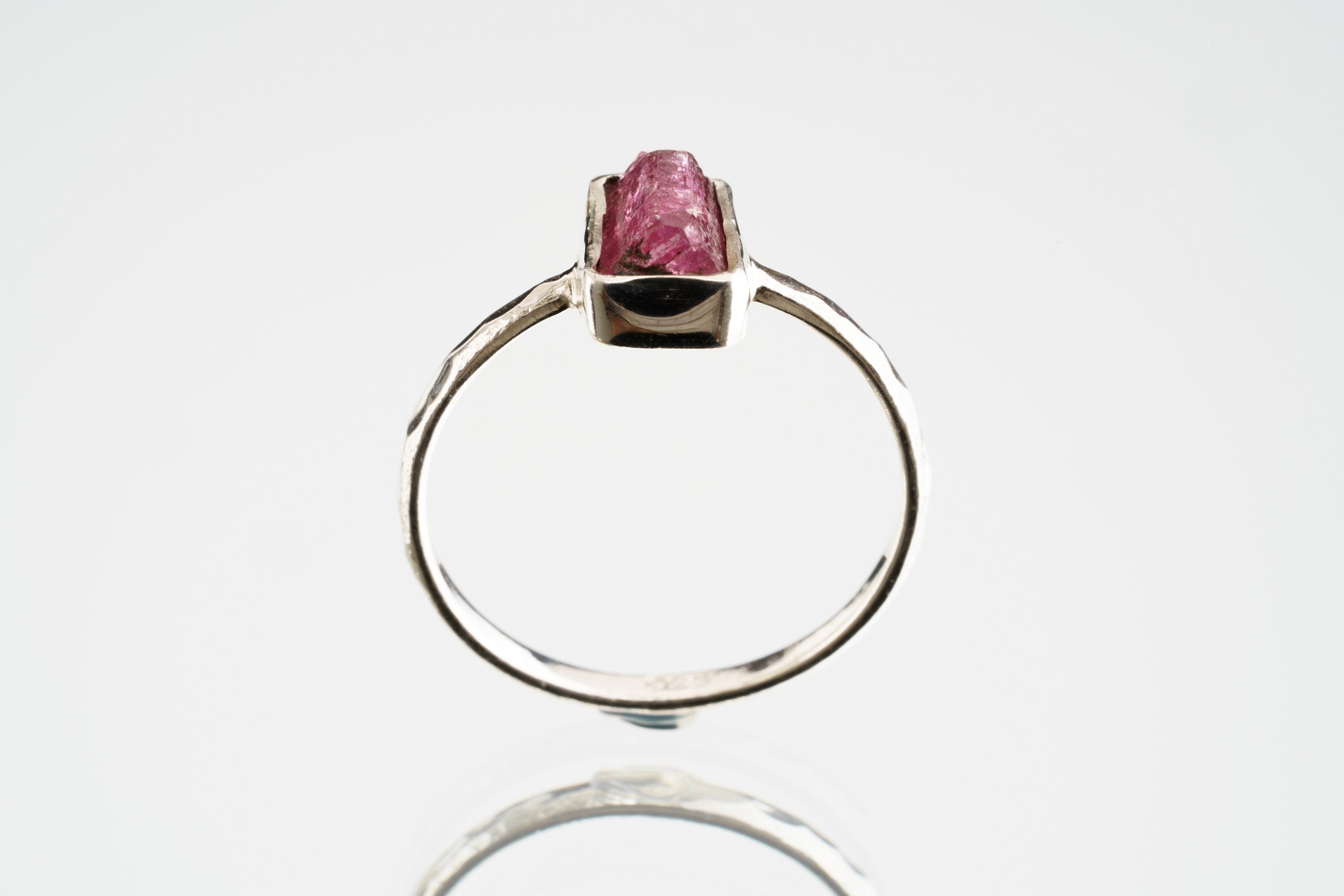 Side profile of Pink Tourmaline sterling silver ring showing the rose gemstone, raised bezel setting, and handmade band shape.