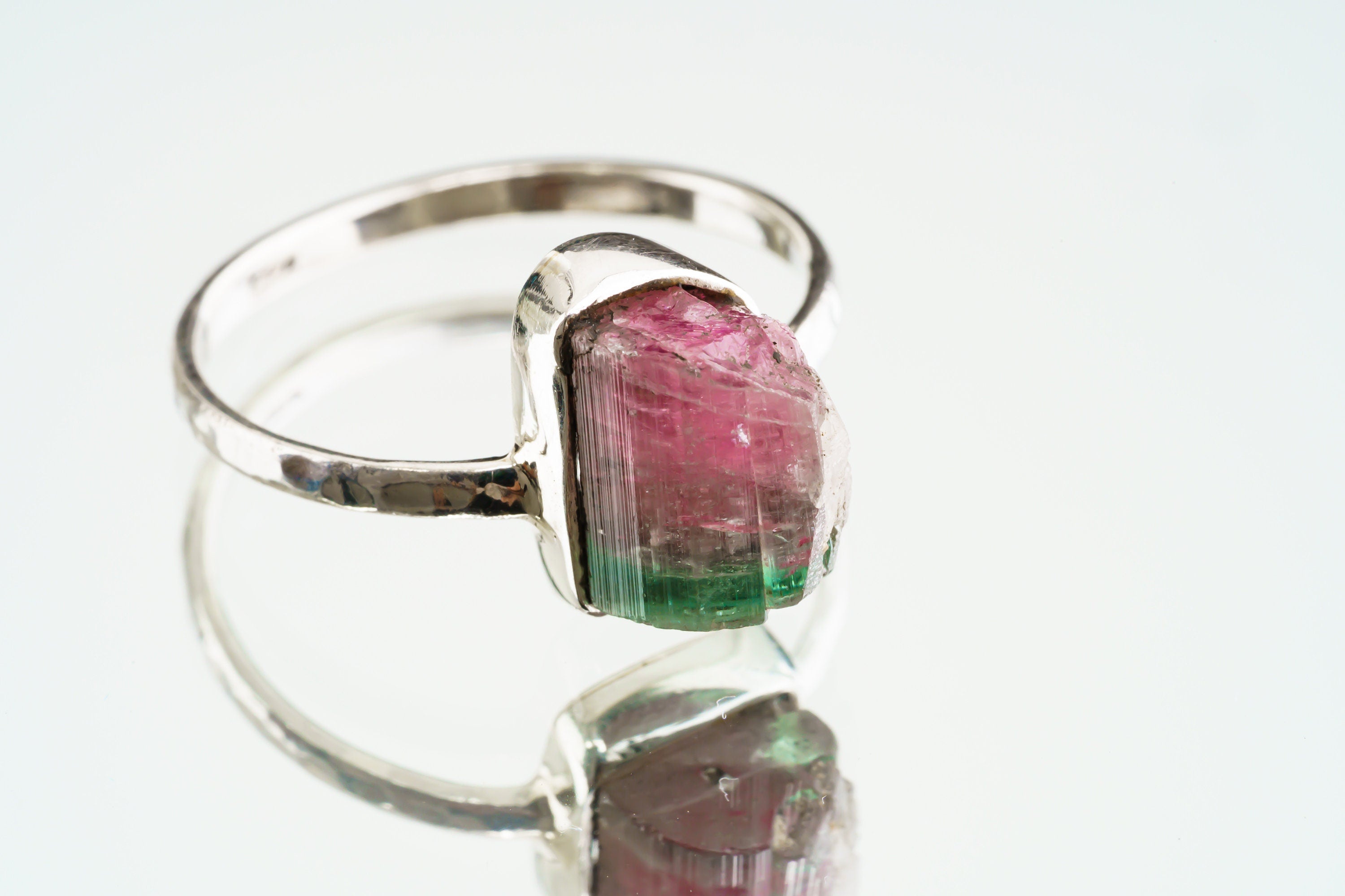Watermelon Tourmaline sterling silver ring shown on a light background, with colour-zoned gemstone and handmade silver band.