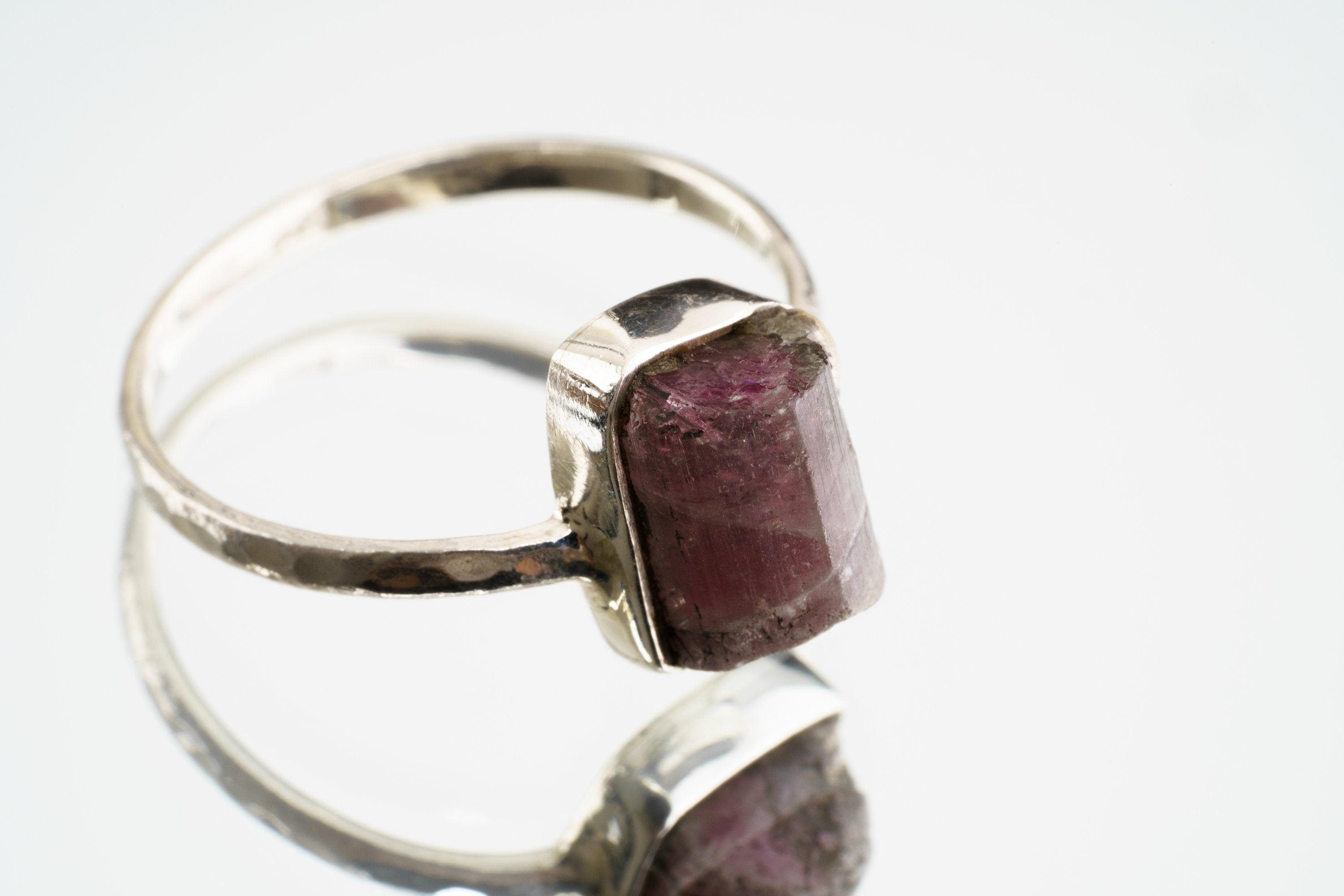 Pink Tourmaline sterling silver ring shown on a light background, with smoky rose gemstone and handmade silver setting.