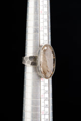 Rutilated Quartz ring shown beside a ruler for scale, with oval stone and oxidized 925 sterling silver construction.