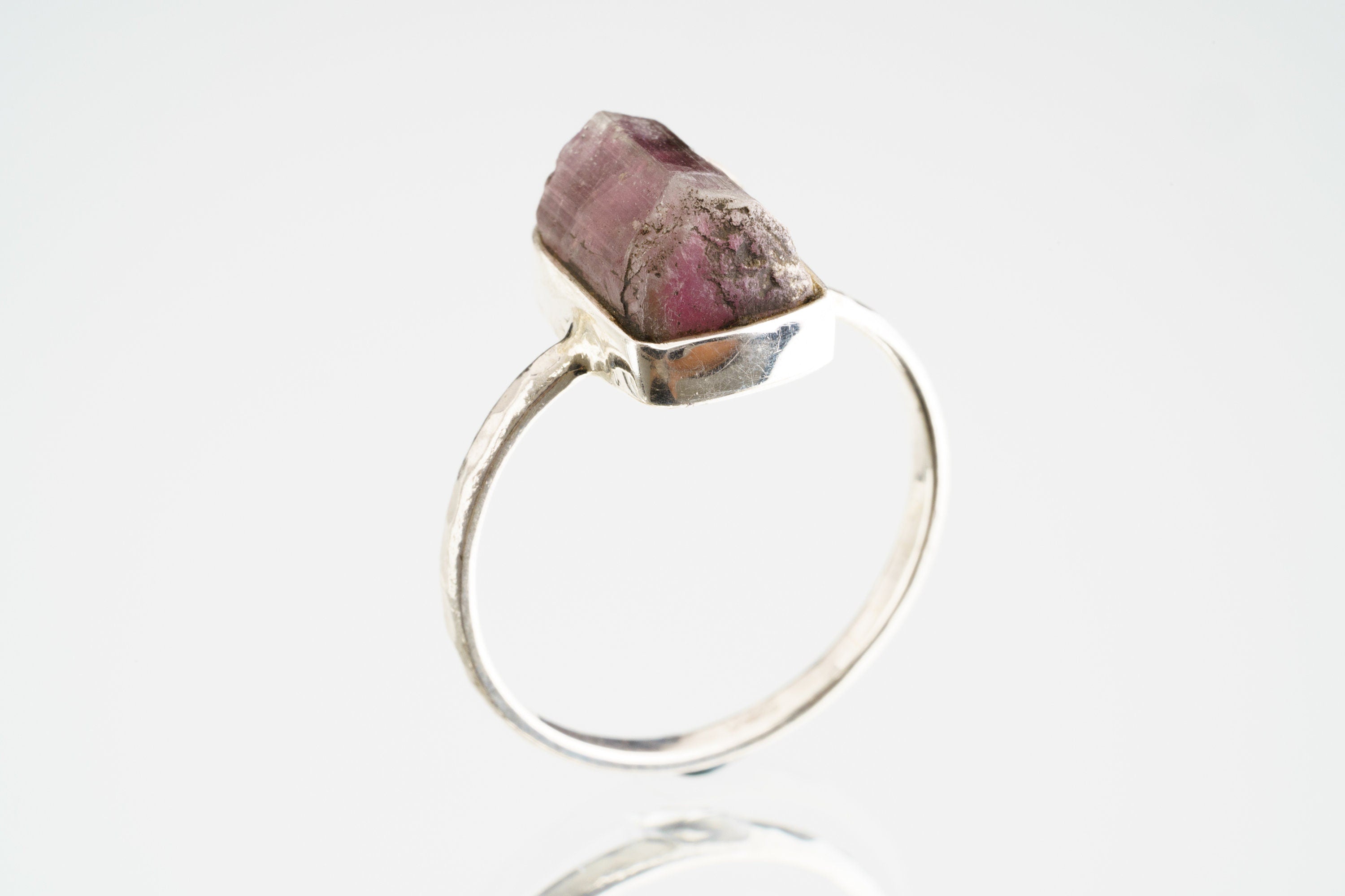 Side view of Pink Tourmaline silver ring showing the raised deep rose stone and sturdy handmade sterling silver band.