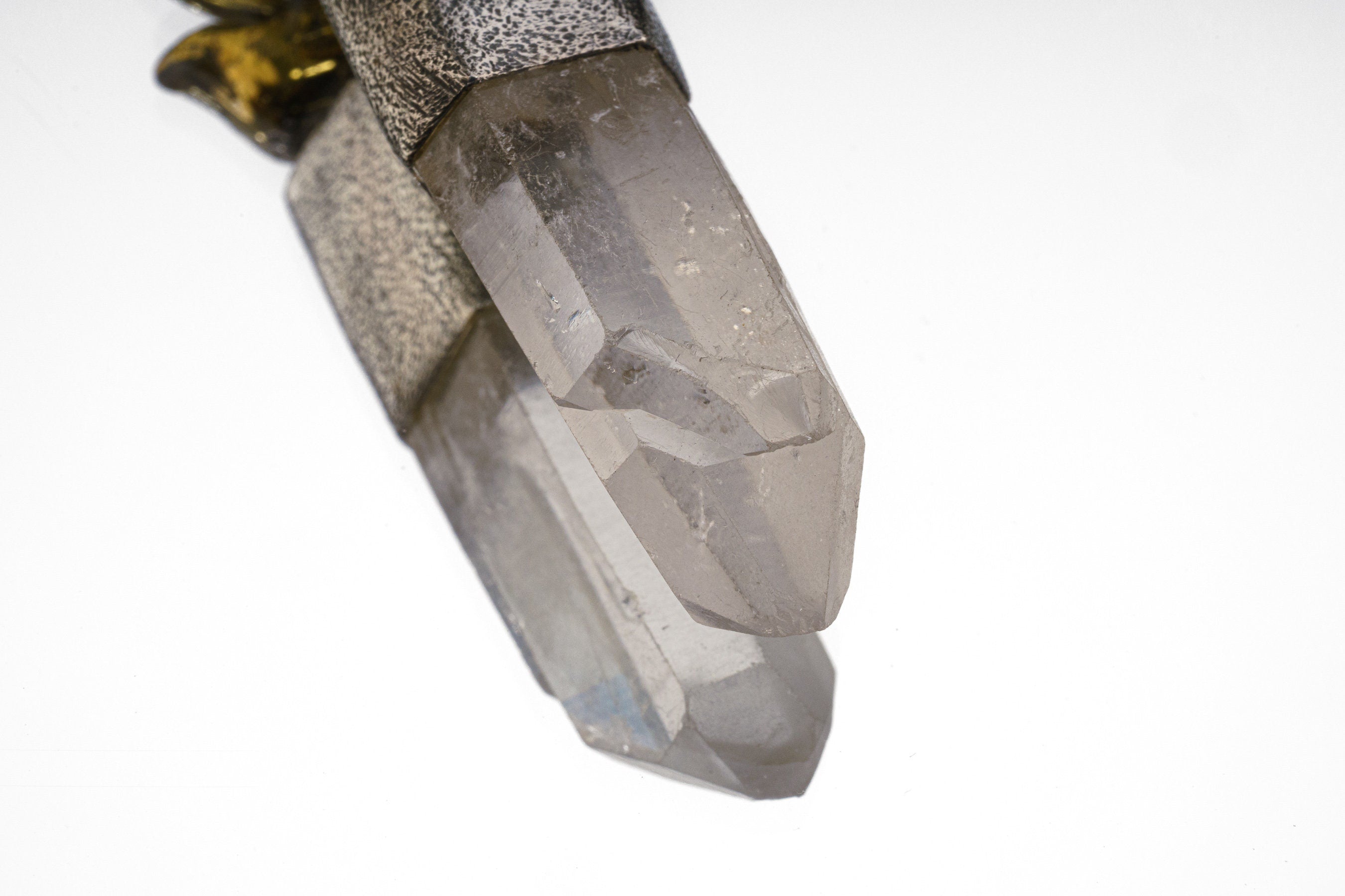 Close-up of Clear Quartz crystal point in a handmade sterling silver Carnelian Quartz talisman pendant.