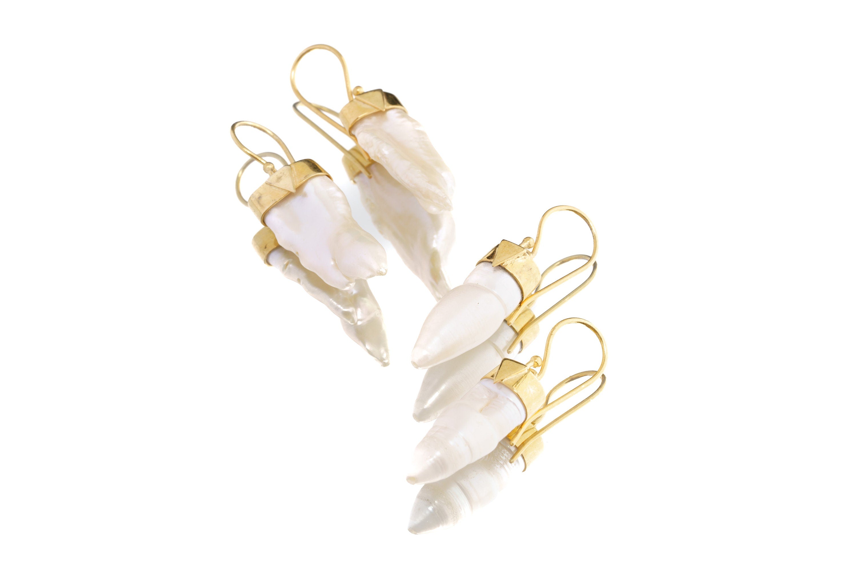 Handmade Pearl earrings shown on a white background, featuring elongated natural Pearls and polished sterling silver.