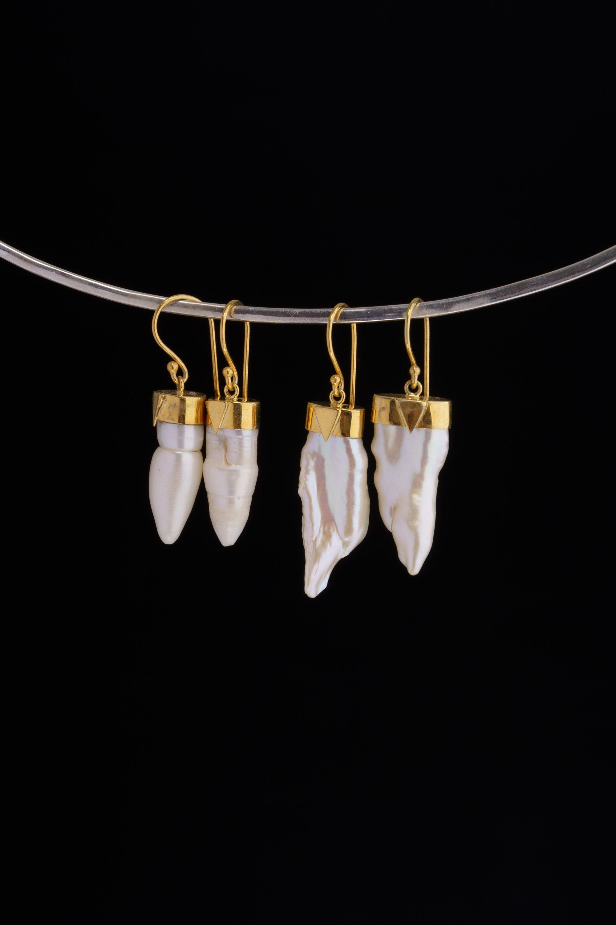 Pearl earrings displayed on a silver choker, showing natural Pearl drops and elegant handmade construction.