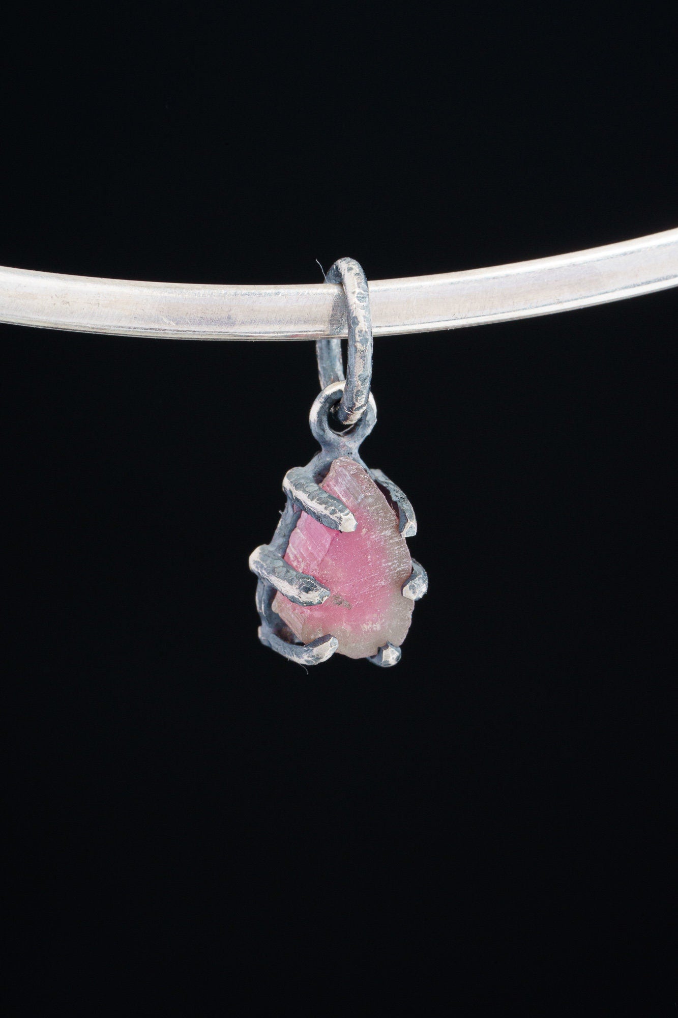 Watermelon Tourmaline pendant on white background showing handmade oxidized silver claw frame and raw crystal detail.