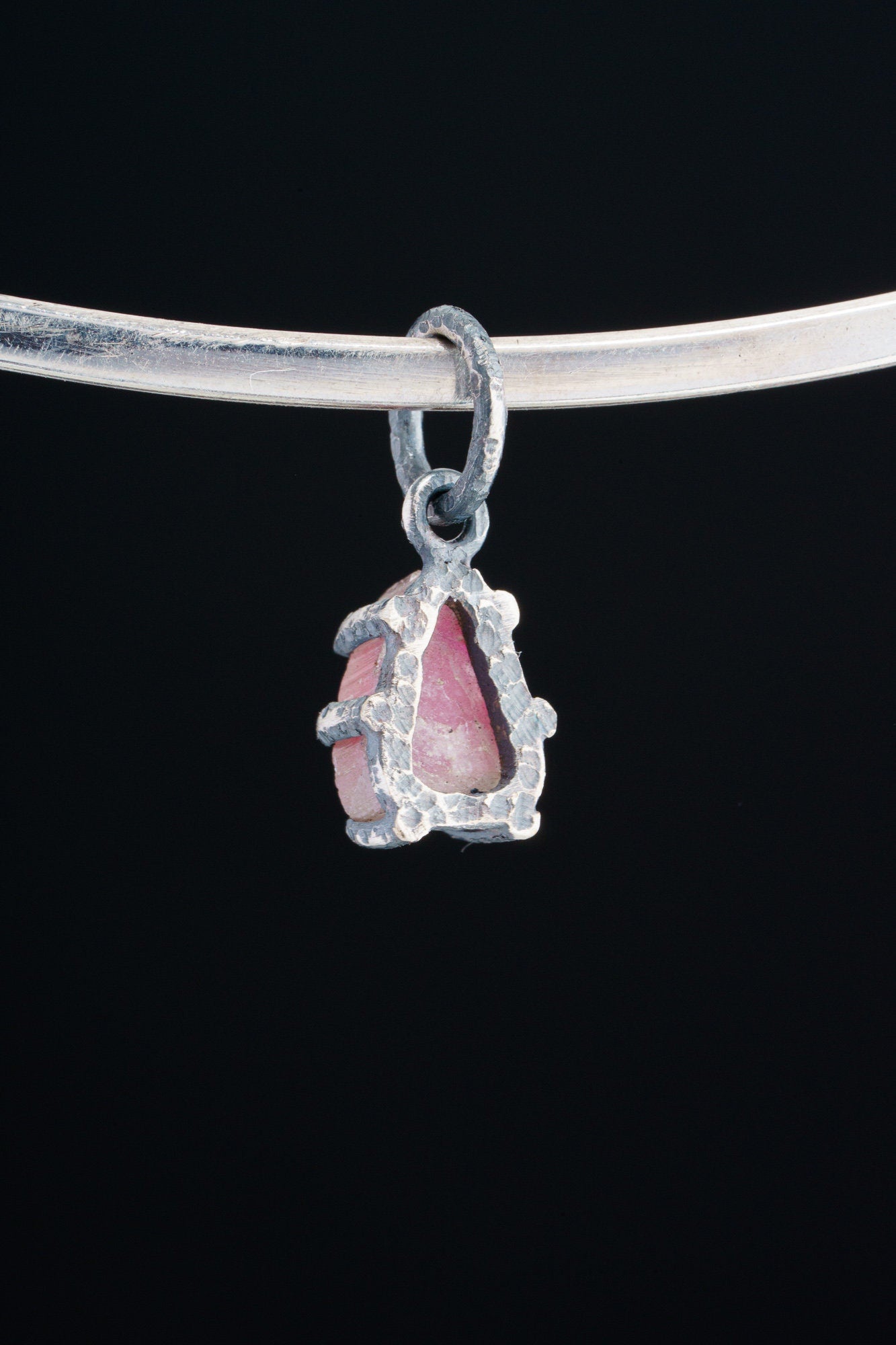 Watermelon Tourmaline Claw Pendant shown worn on a silver choker with compact oxidized silver setting.