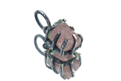 Watermelon Tourmaline Claw Pendant on white background with oxidized sterling silver and natural pink-green crystal.