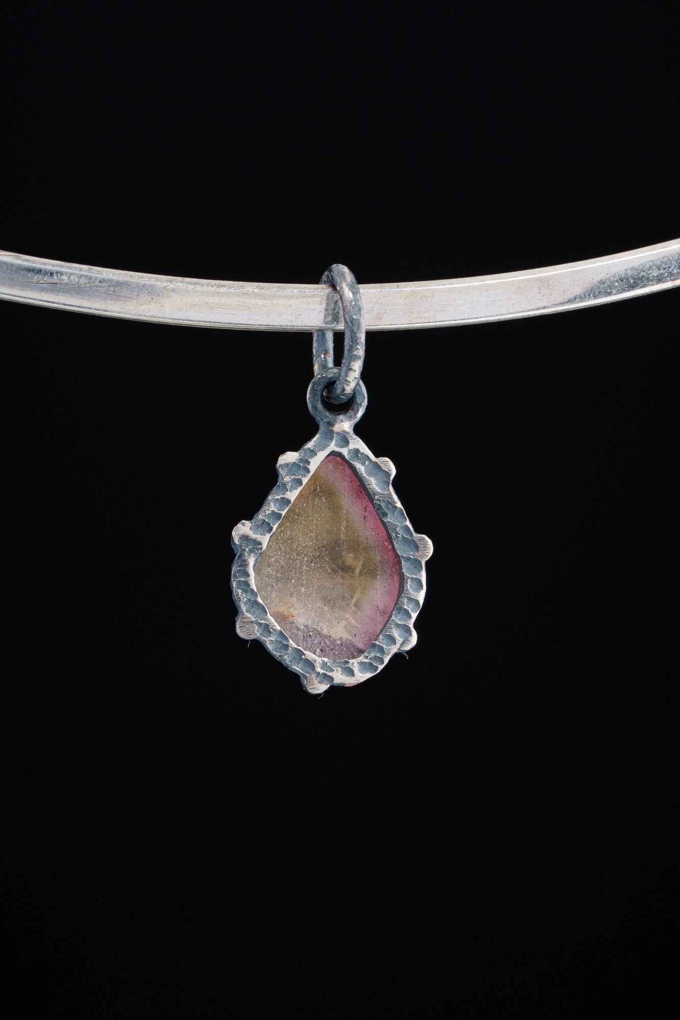 Watermelon Tourmaline Claw Pendant shown worn on a silver choker with small oxidized silver setting.