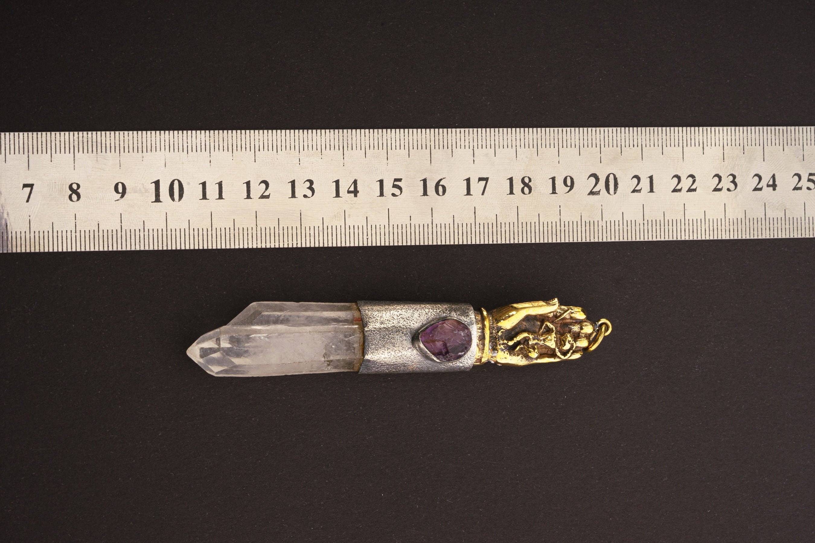 Sun Wukong Buddha Hand Clear Quartz Amethyst pendant shown beside a ruler for scale with mixed crystal talisman setting.