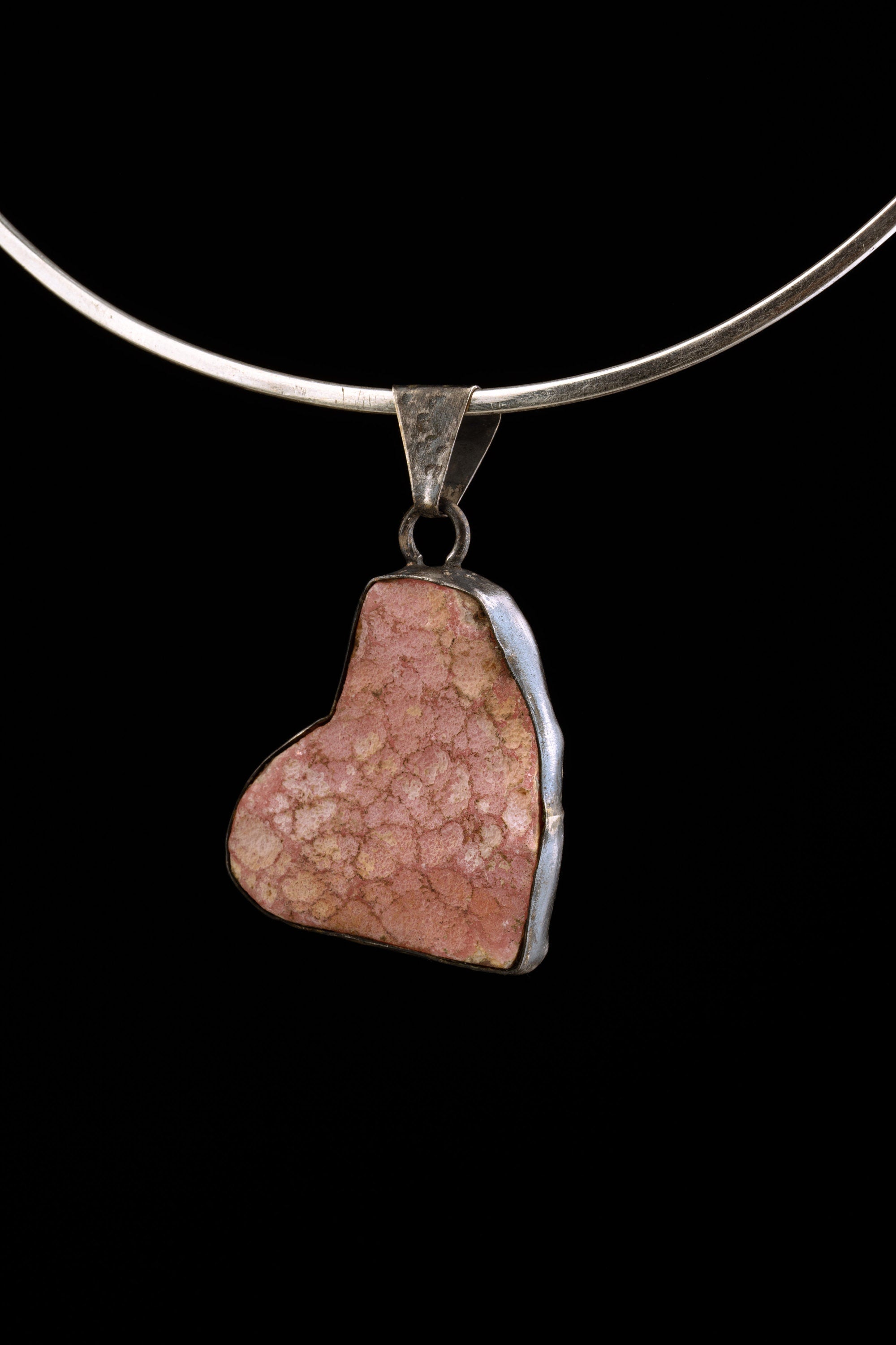 Rhodochrosite pendant worn on a choker as a Heart Chakra sterling silver necklace.