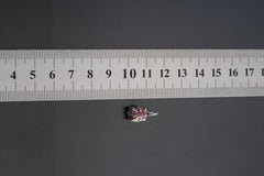 Pink Tourmaline Rubellite pendant shown beside ruler for scale 1.5cm with rose-pink crystal in oxidized silver claw setting.