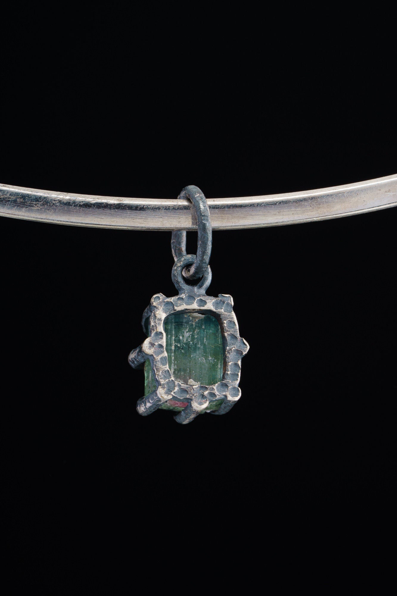 Watermelon Tourmaline pendant shown beside ruler for scale with pink-green crystal in oxidized silver claw setting.