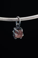 Pink Tourmaline Rubellite Claw Pendant on black background with oxidized sterling silver and natural rose-pink crystal.
