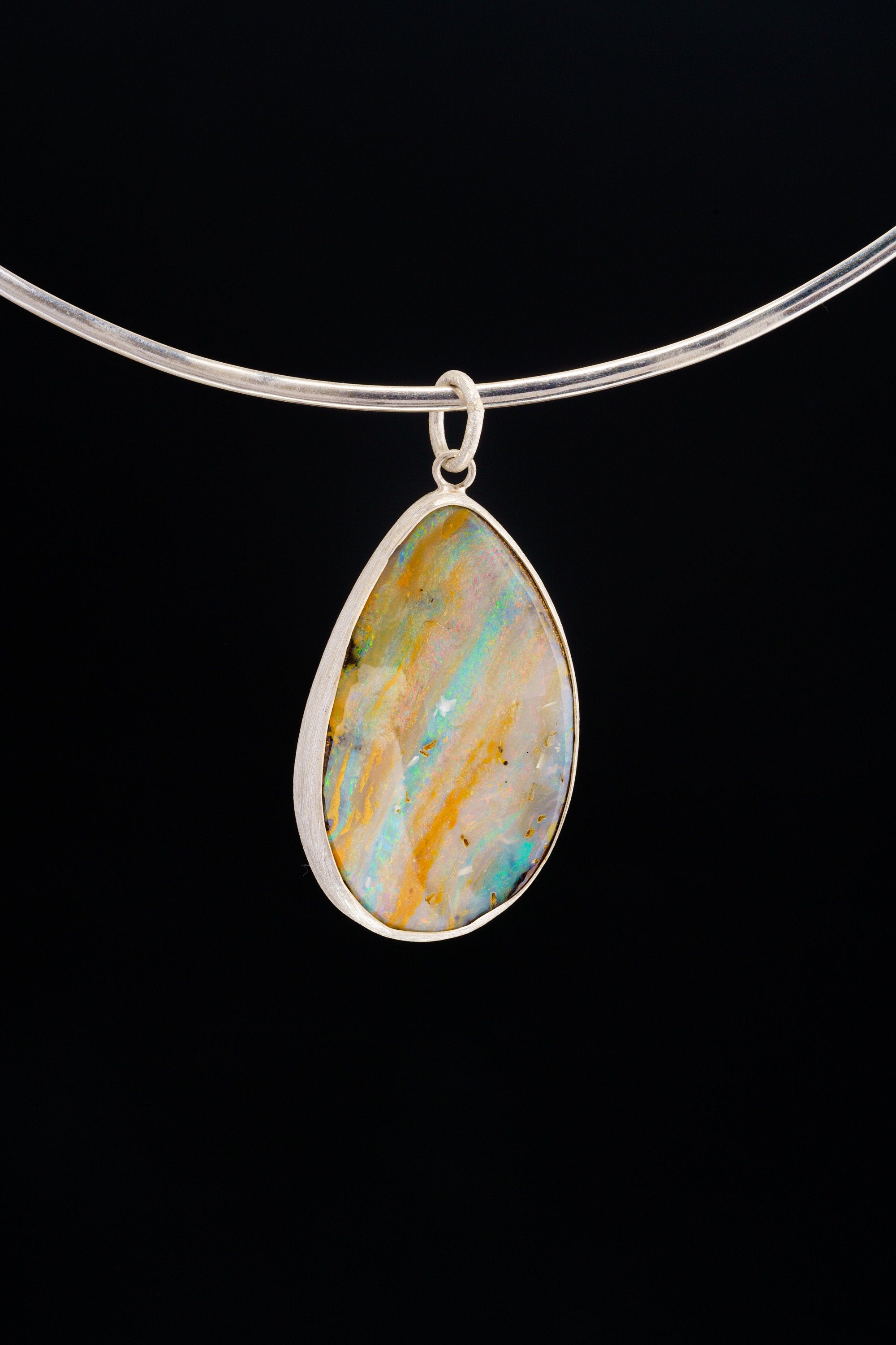 Back view of Lightning Ridge Boulder Opal pendant showing open-back sterling silver bezel and natural opal matrix.