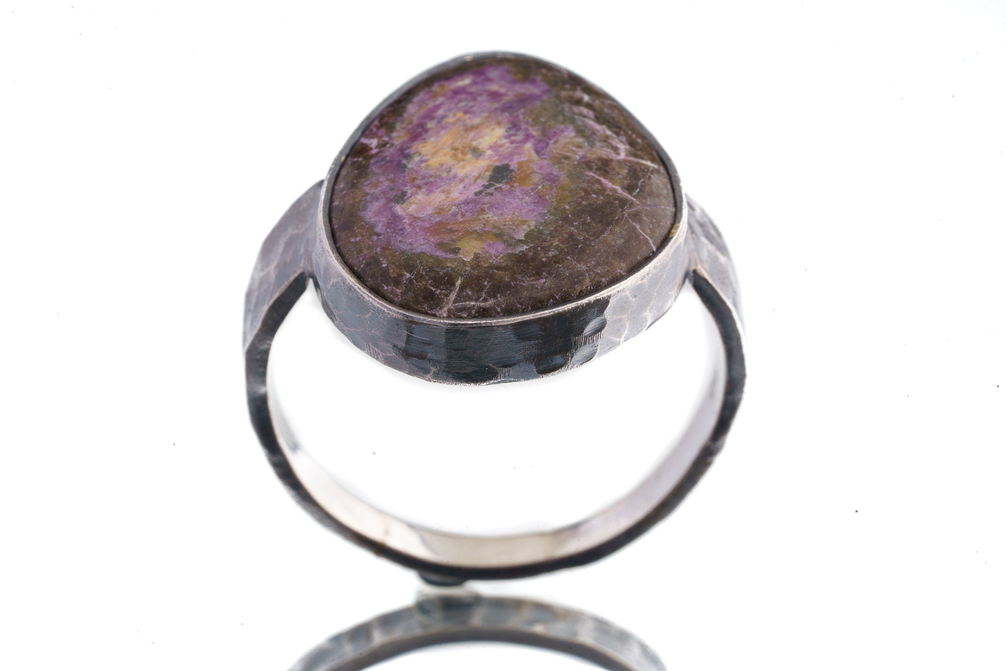 Front view of Sugilite oxidized silver ring showing purple mineral stone and rugged hammered sterling silver profile.