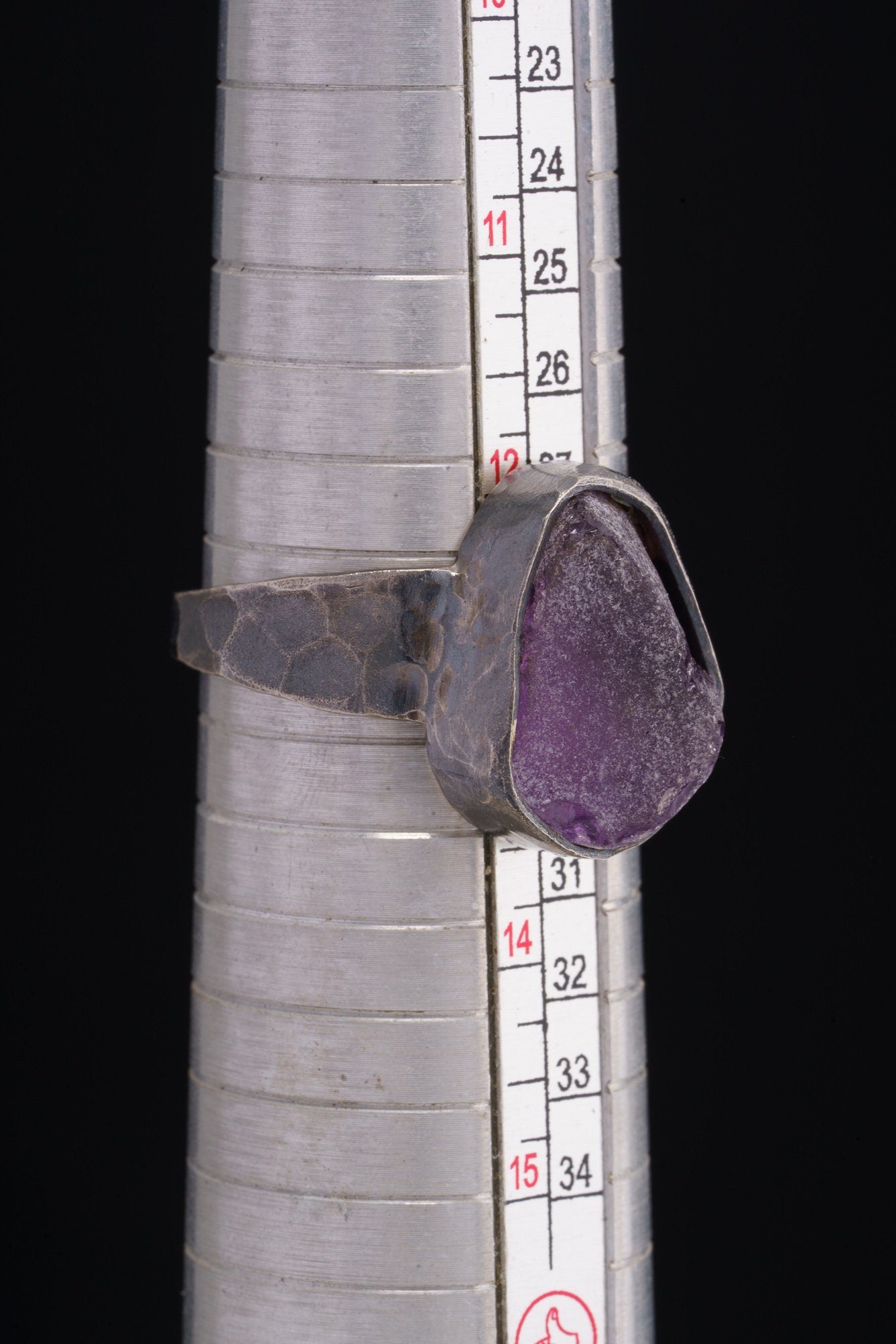 Amethyst oxidized silver ring shown beside a ruler for scale, with hammered 925 sterling silver construction.