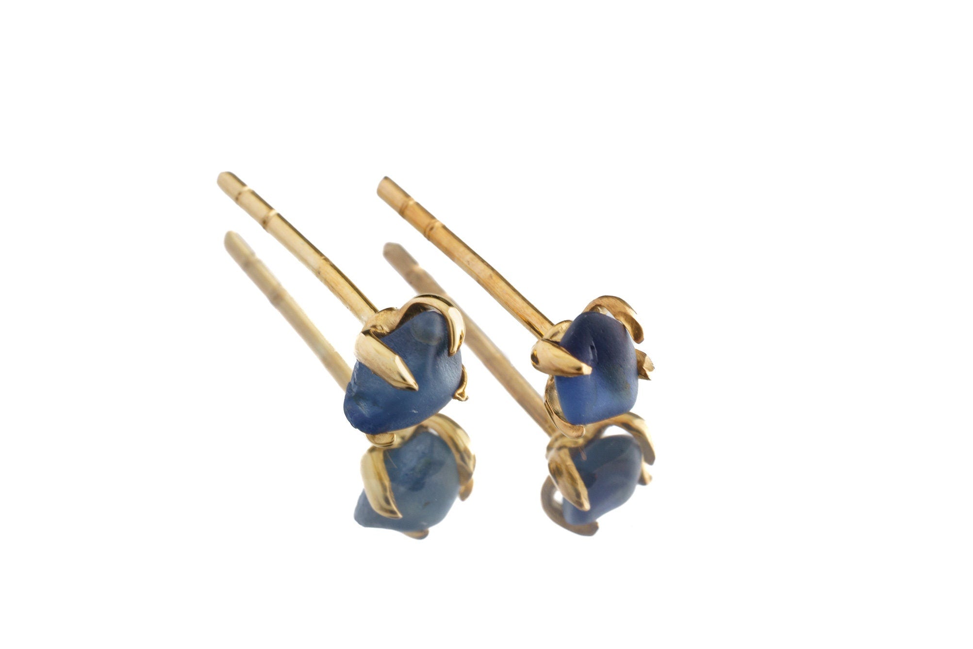 Gold-plated Australian Sapphire claw stud earrings shown on white background with natural blue stones.