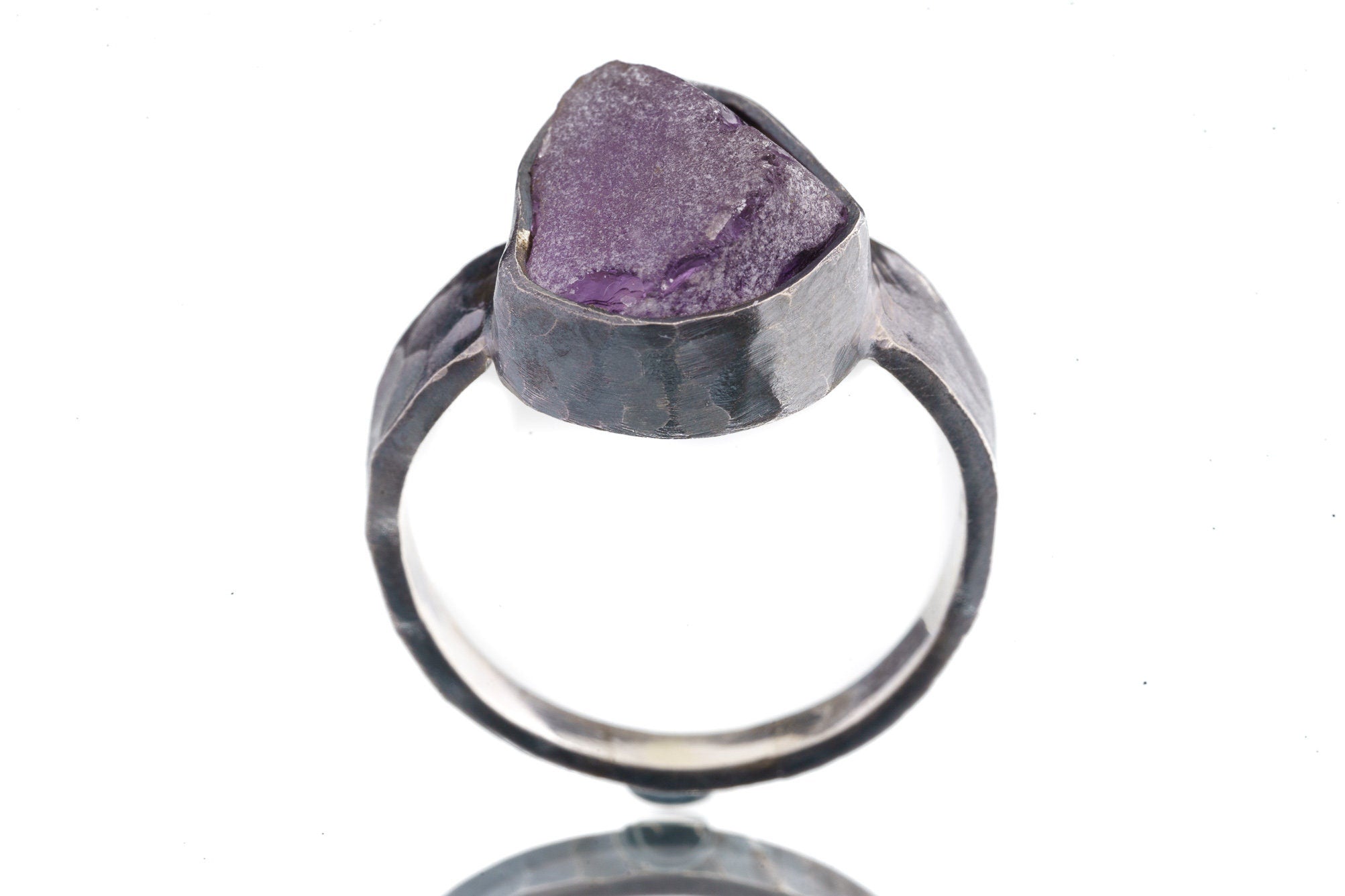 Front view of Amethyst oxidized silver ring showing rugged hammered band texture and purple gemstone setting.