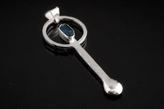 Blue Apatite sterling silver ritual spoon shown on dark background with hand-hammered silver and blue gemstone setting.