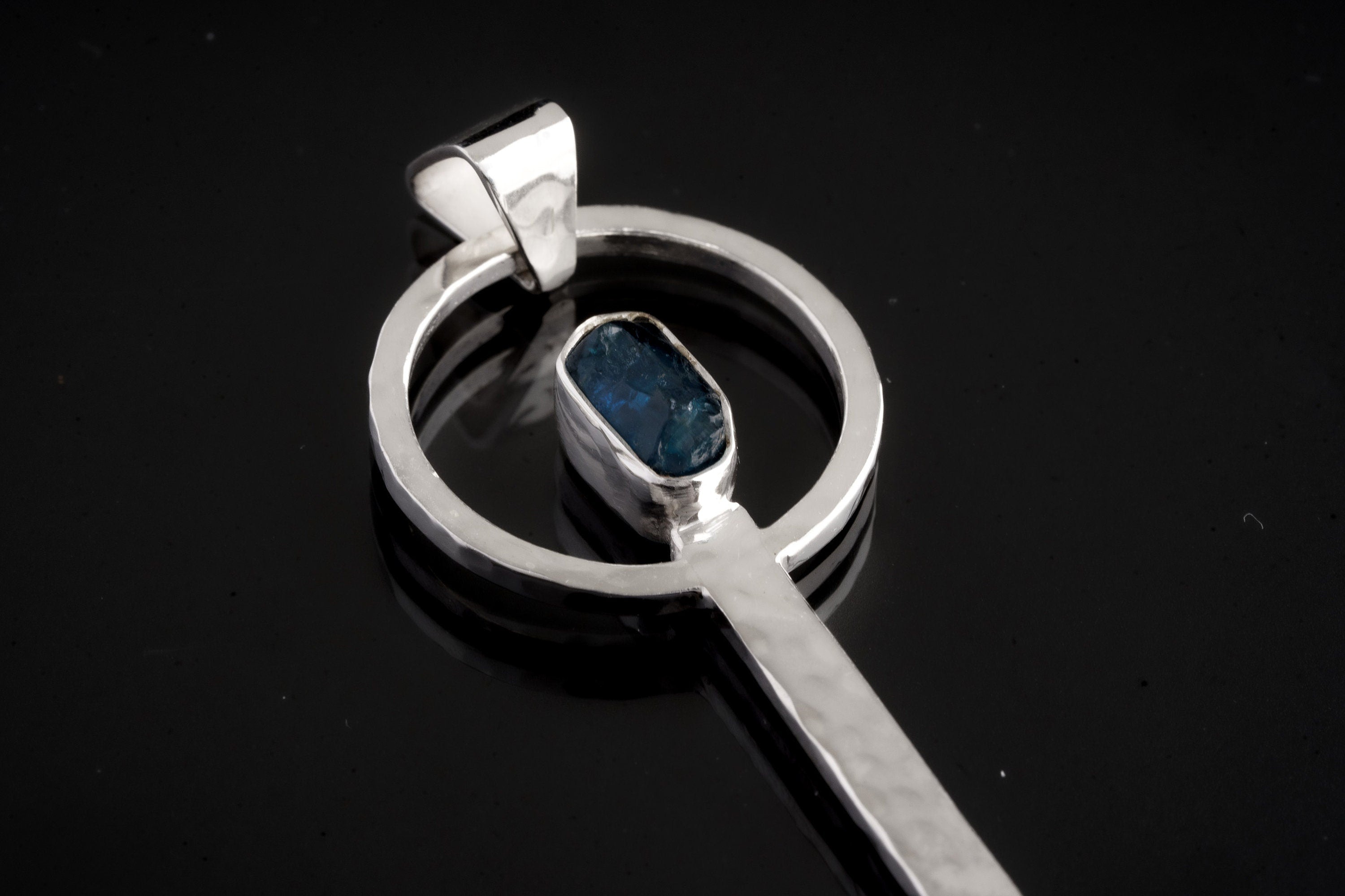 Close-up of Blue Apatite ritual spoon showing hammered sterling silver setting and vivid blue gemstone.