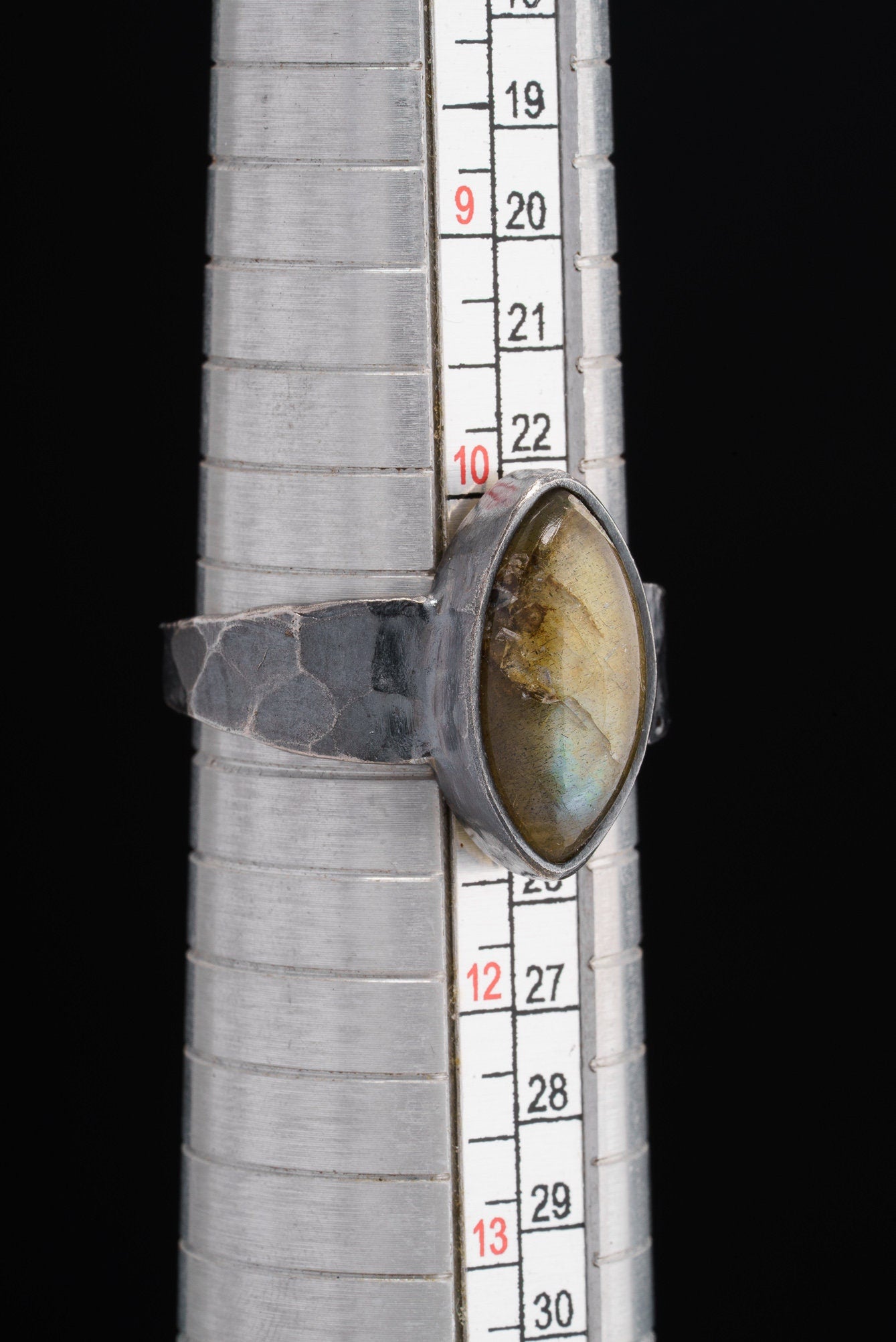 Labradorite oxidized silver ring shown beside a ruler for scale, with rugged 925 sterling silver construction.