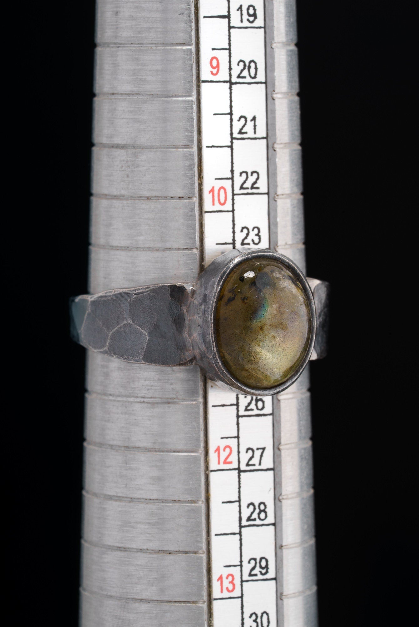 Labradorite oxidized silver ring shown beside a ruler for scale, with rugged 925 sterling silver construction.