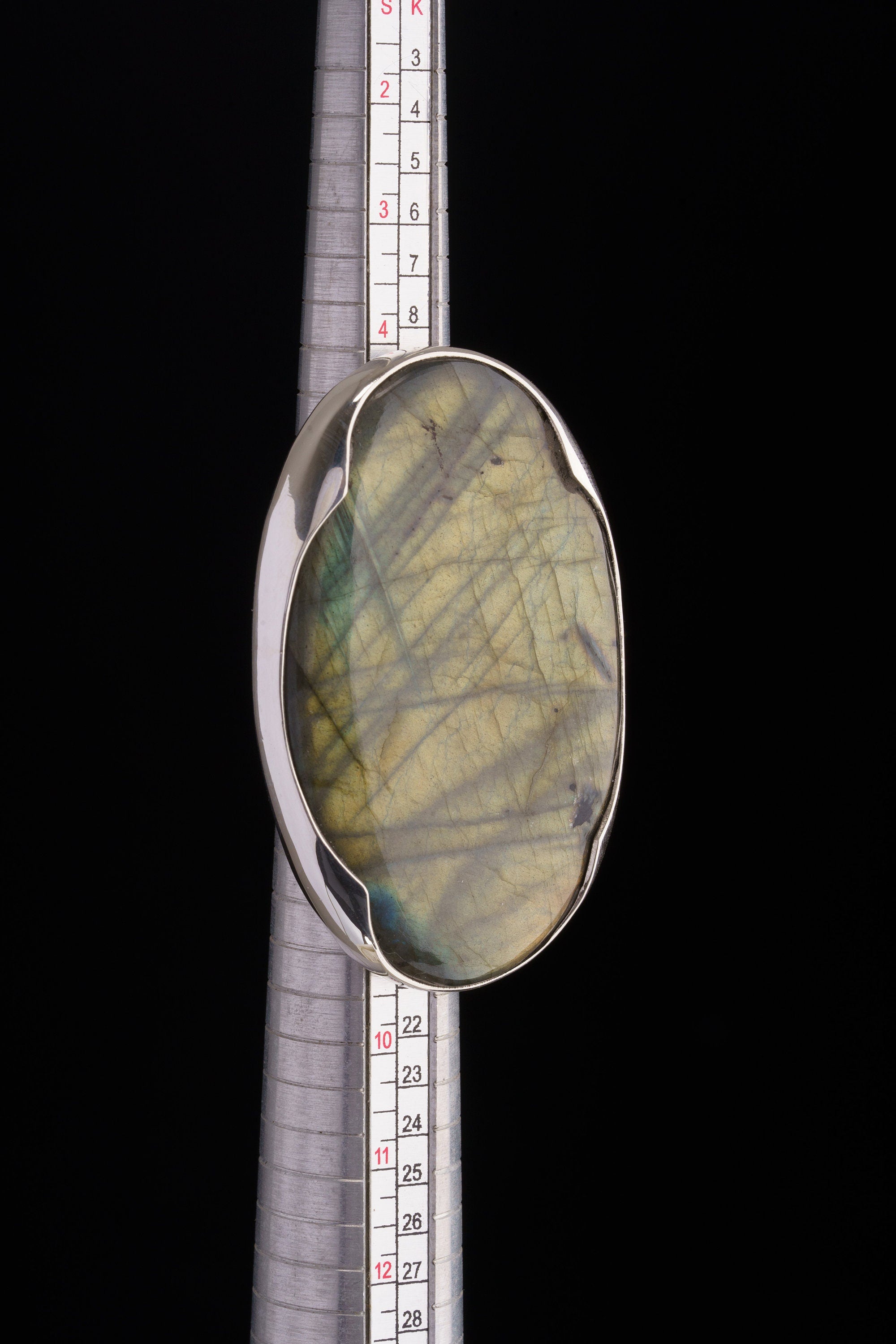 XXL Labradorite adjustable ring shown beside a ruler for scale, with shiny 925 sterling silver and bold stone presence.