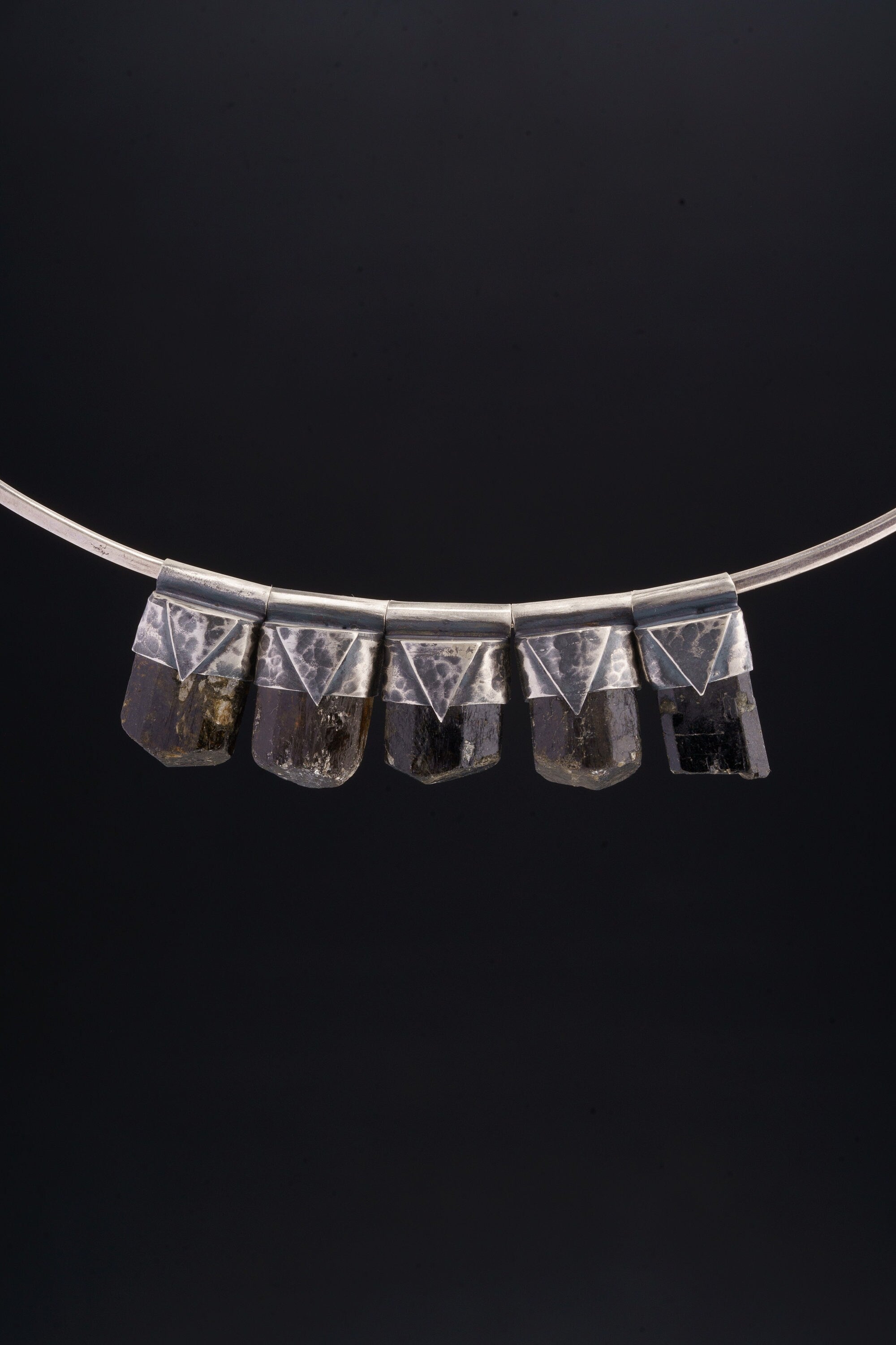 Himalayan Dravite Tourmaline Stack Pendants shown together on black background with oxidized silver caps and smoky brown-black stones.