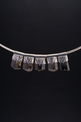 Himalayan Dravite Tourmaline Stack Pendants shown together on black background with oxidized silver caps and smoky brown-black stones.