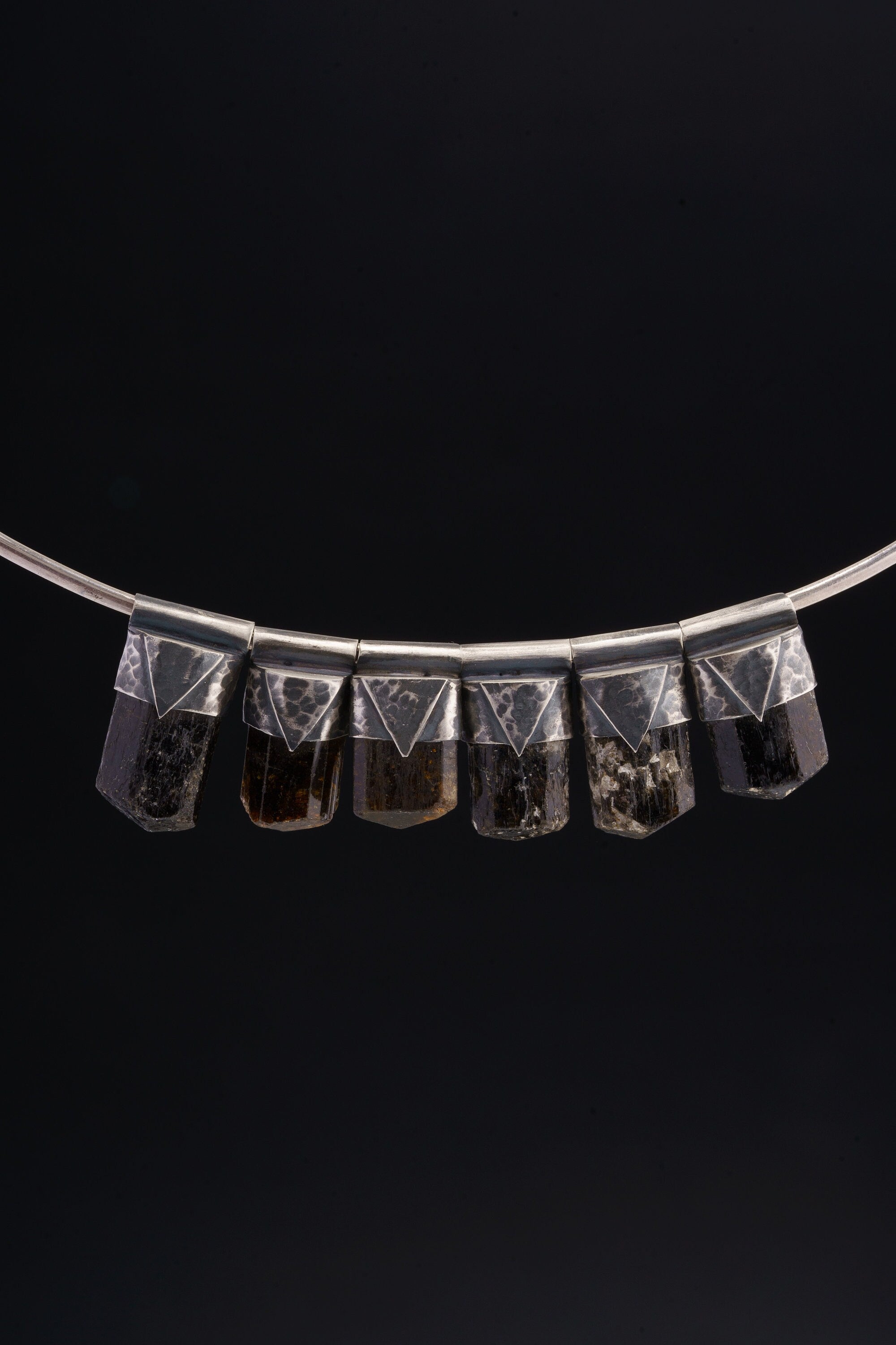 Himalayan Dravite Tourmaline Stack Pendants shown together on black background with oxidized silver caps and smoky brown-black stones.
