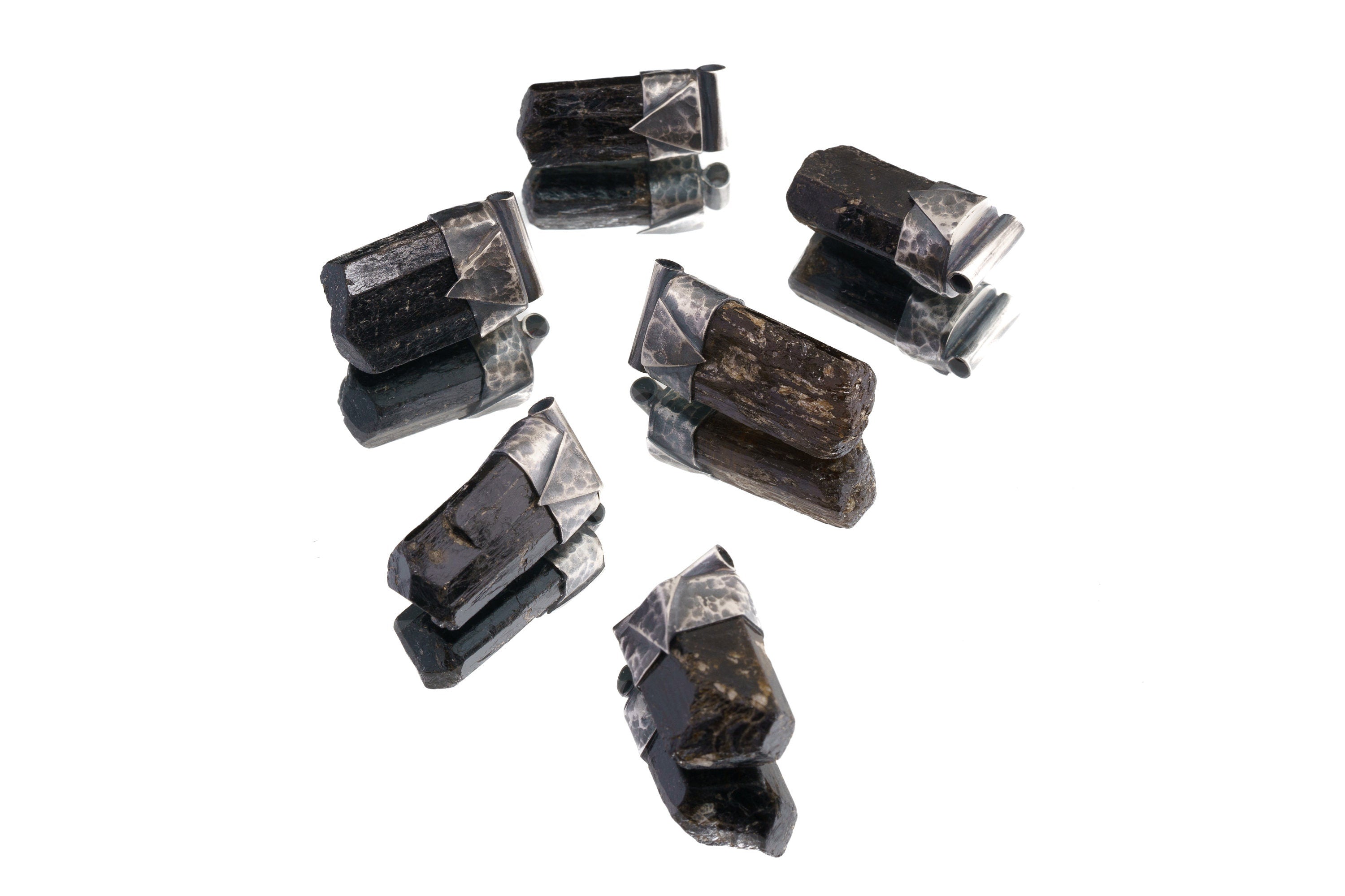 Group of Himalayan Dravite Tourmaline Stack Pendants shown on white background with dark terminated crystals and silver caps.