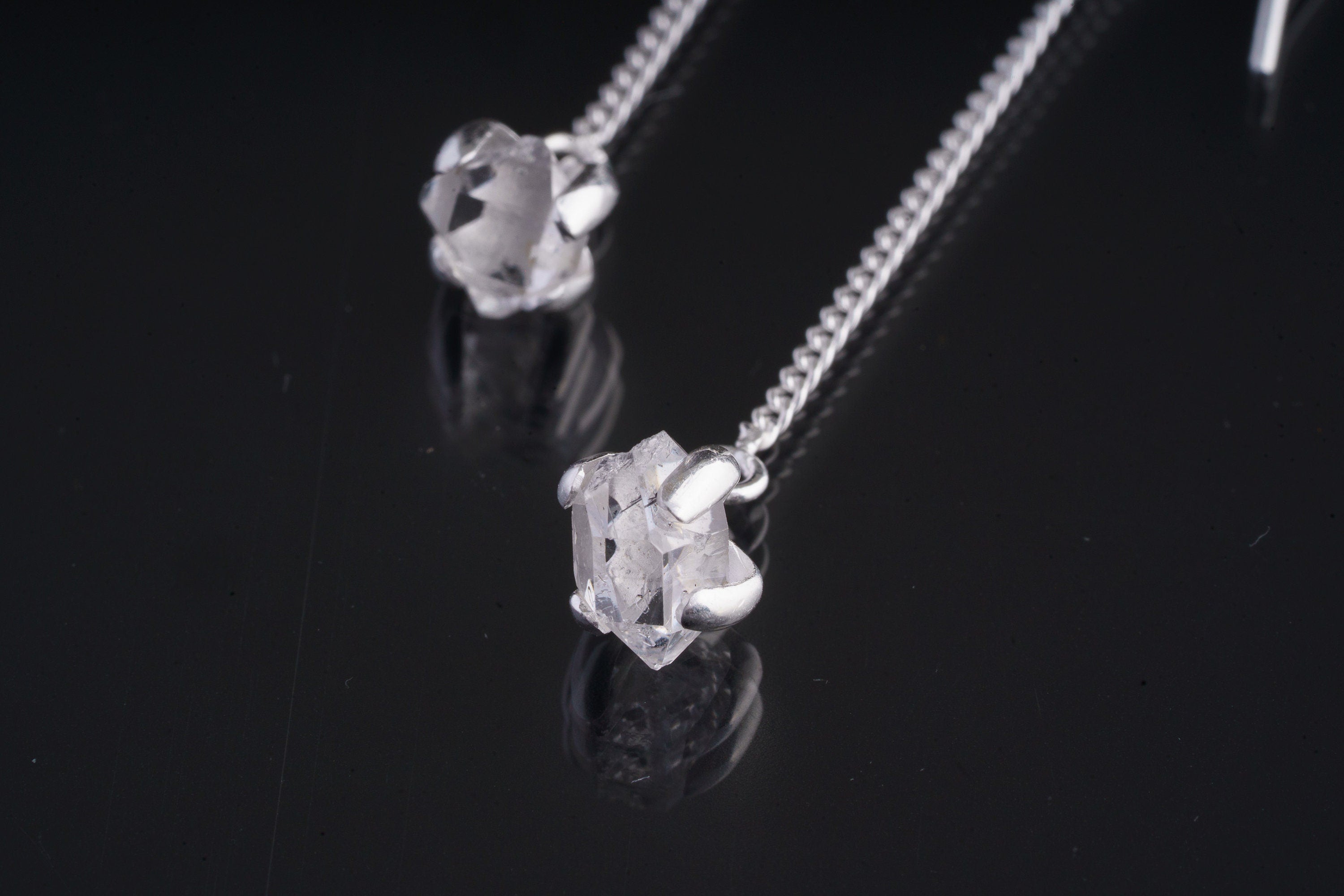 Close-up of Herkimer Diamond Quartz earring showing claw-set crystal, polished silver, and natural sparkle.