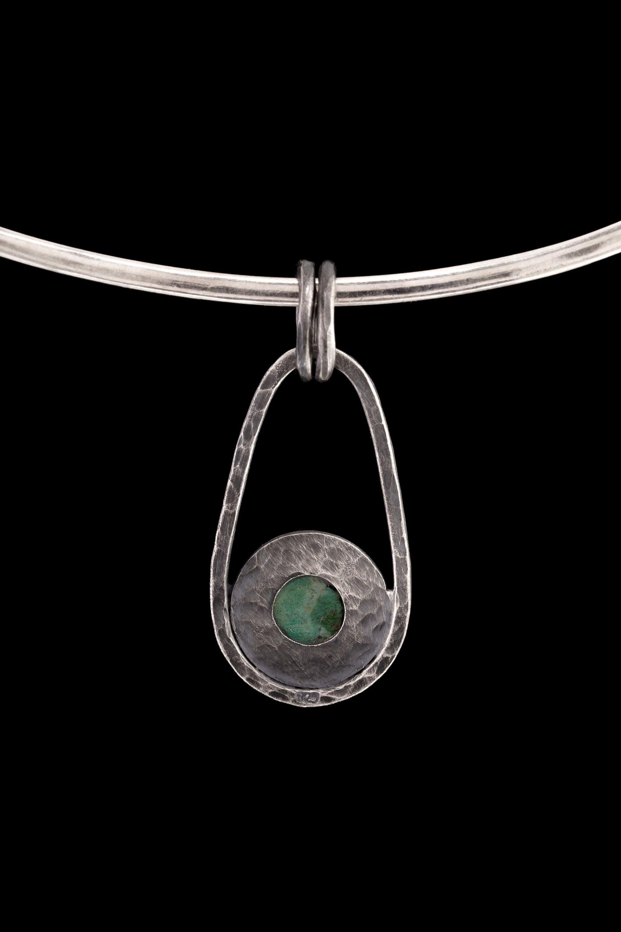 Single Royston Turquoise pendant on black background with oxidized sterling silver frame, dual bail, and celestial ray accents.