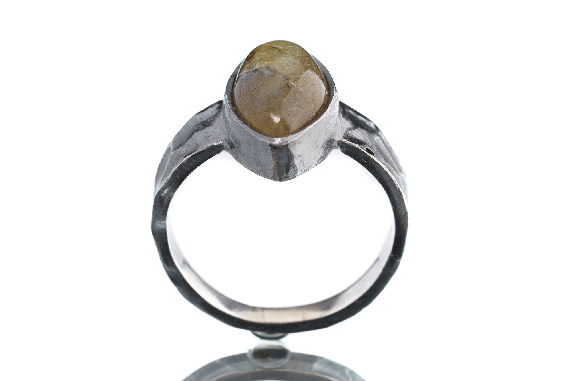 Front view of Labradorite oxidized silver ring showing hammered band texture and natural flashing gemstone centre.