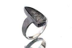 Rutilated Quartz ring in oxidized 925 sterling silver with hammered texture, open-back bezel, and visible rutile strands.