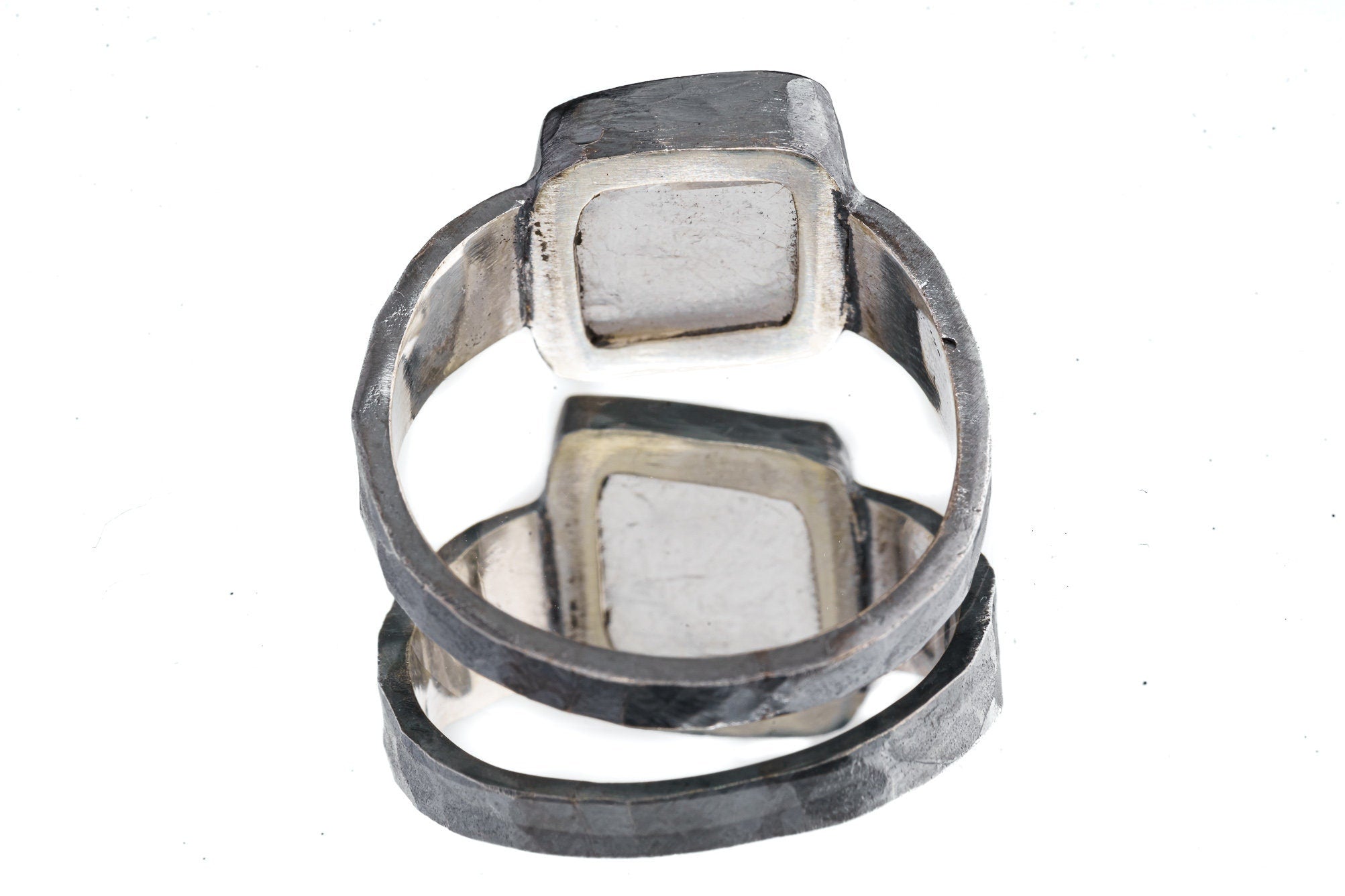 Back view of Selenite oxidized silver ring showing rugged hammered band texture and strong masculine profile.