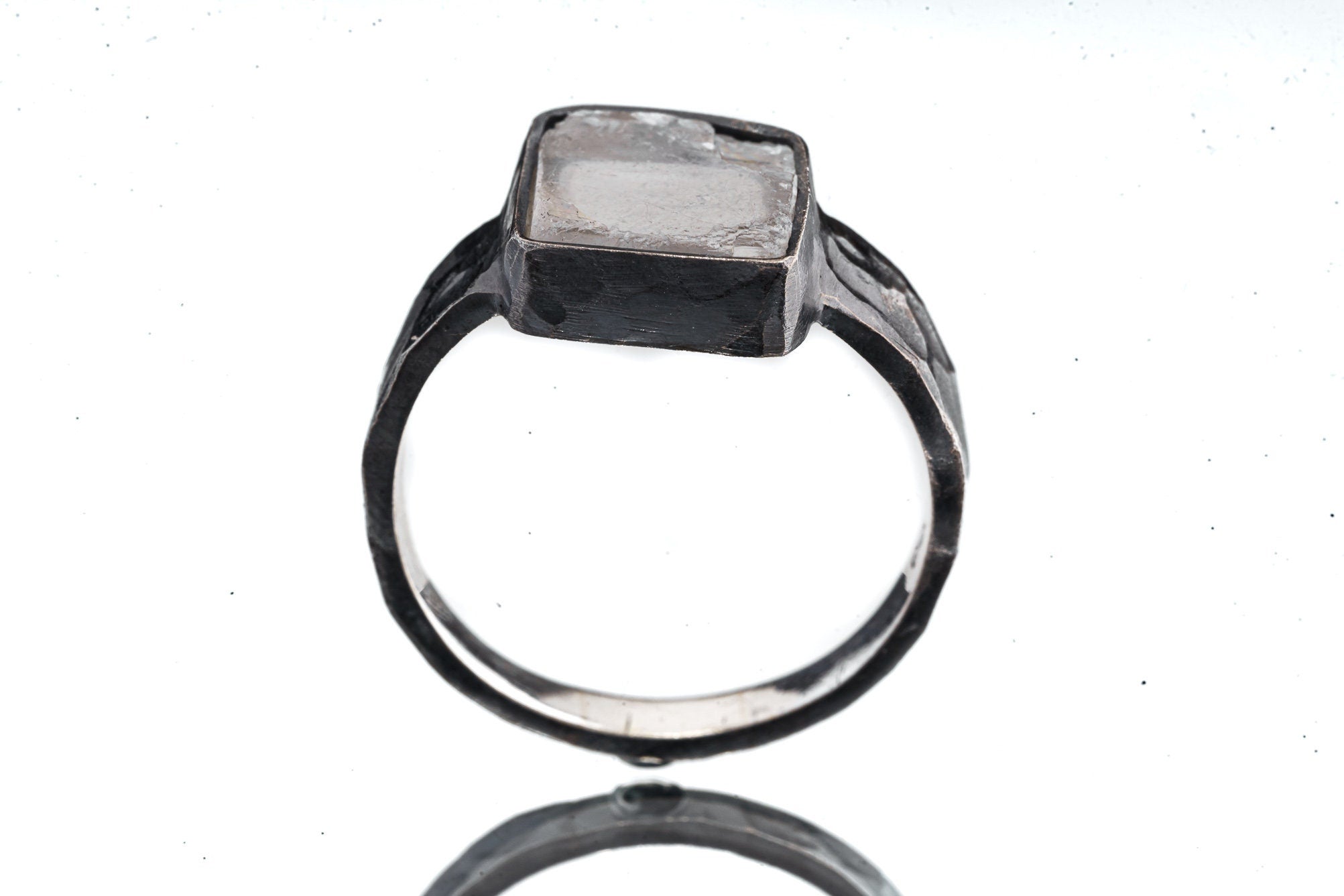Front view of Selenite ring showing pale gypsum stone in dark oxidized sterling silver with open-back construction.