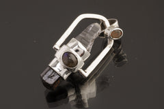 Two Sided Crystal Spinner Pendant shown on black background with Himalayan Laser Quartz, Dravite Tourmaline, and sterling silver spinner setting.