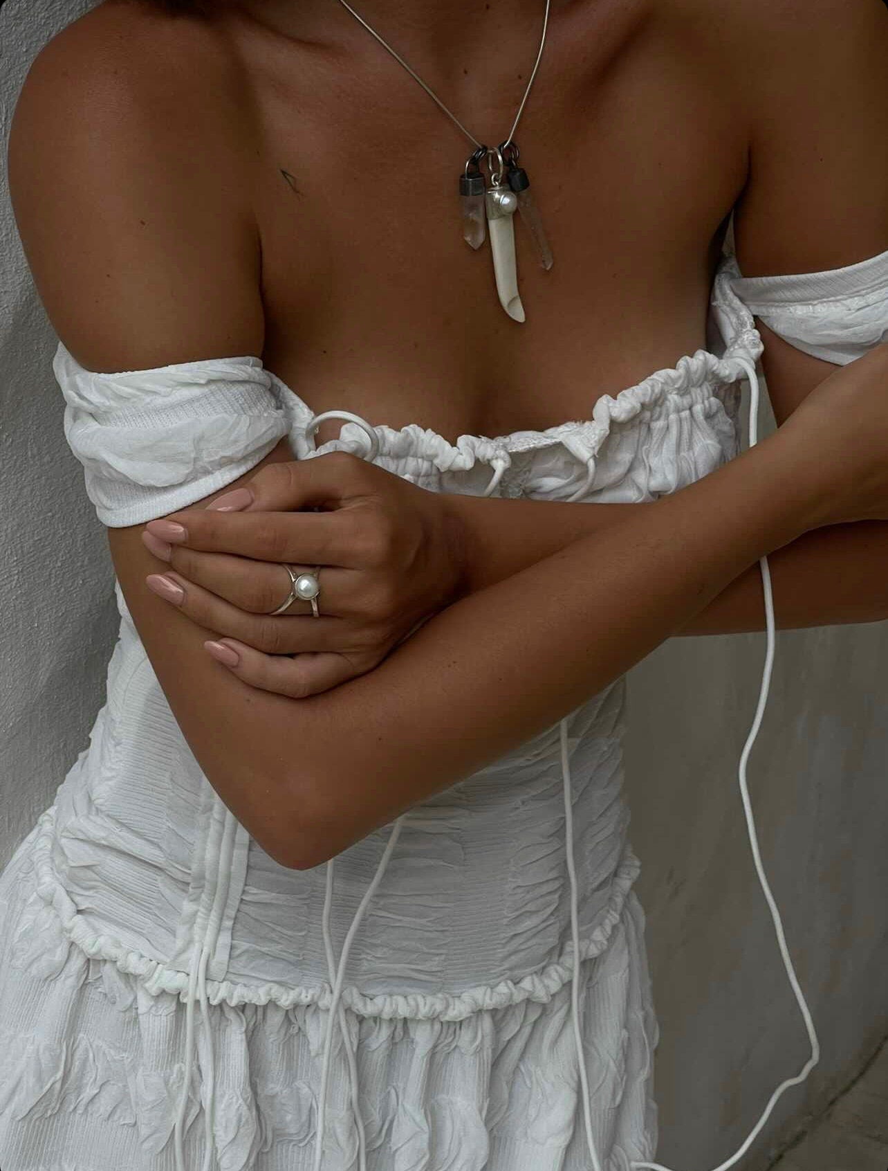 South Sea Pearl Antique Bone Spoon Pendant shown worn on a model as a symbolic ritual talisman.