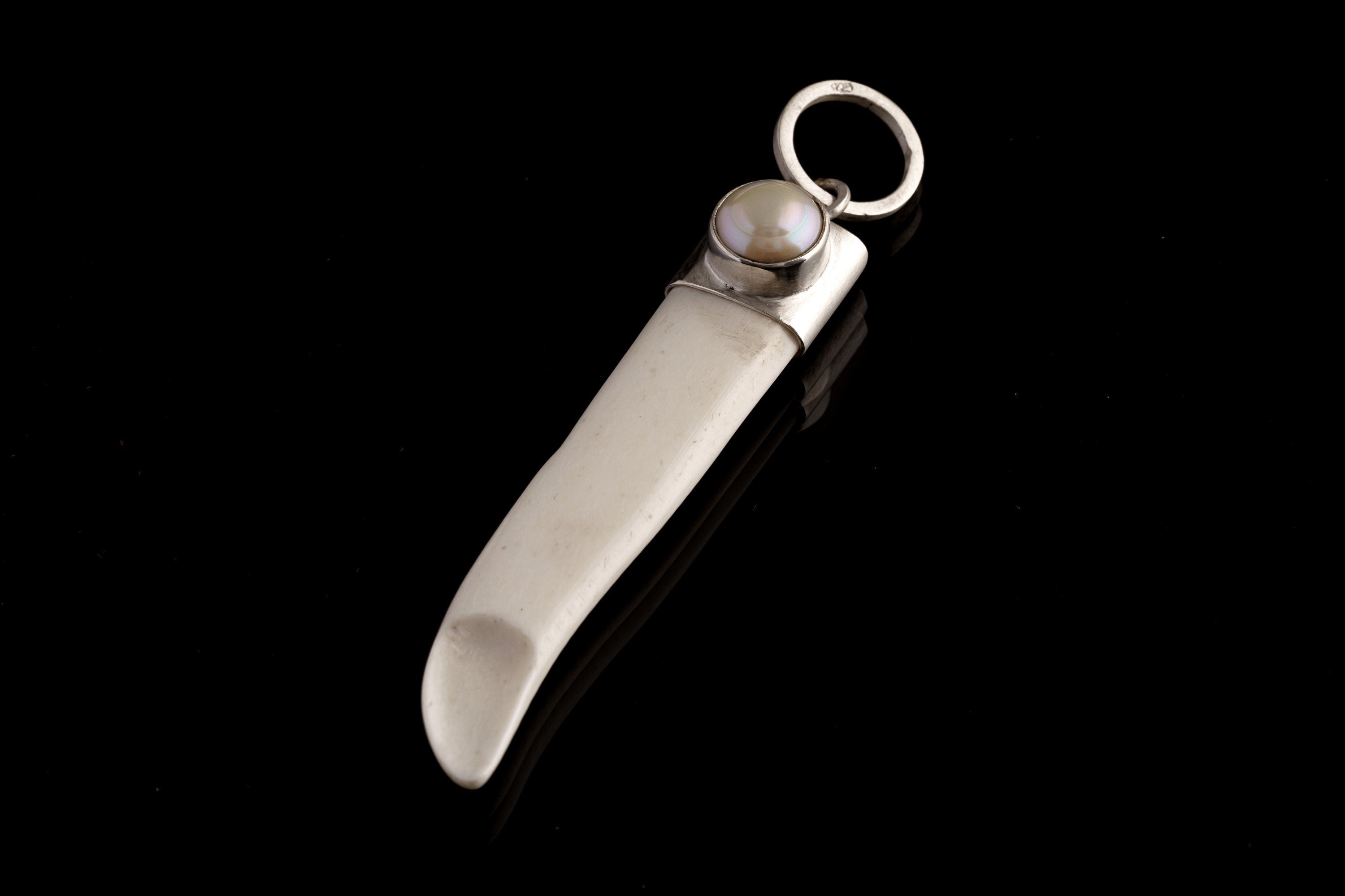 Detailed view of South Sea Pearl and sterling silver cap on antique bone pendant with handmade polished finish.