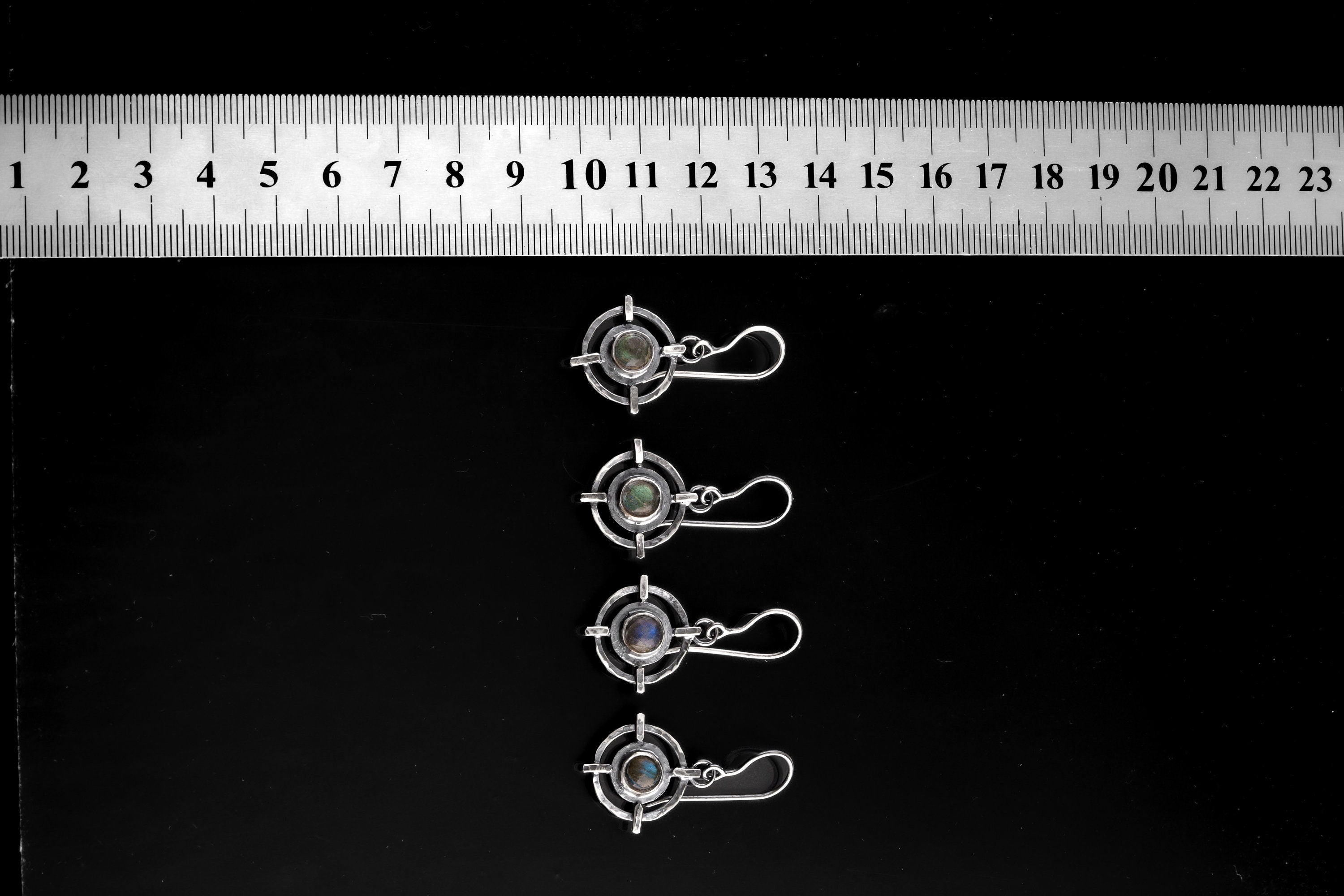 Labradorite Circle Cross earrings shown beside a ruler for scale, with sterling silver fittings and hammered dangles.