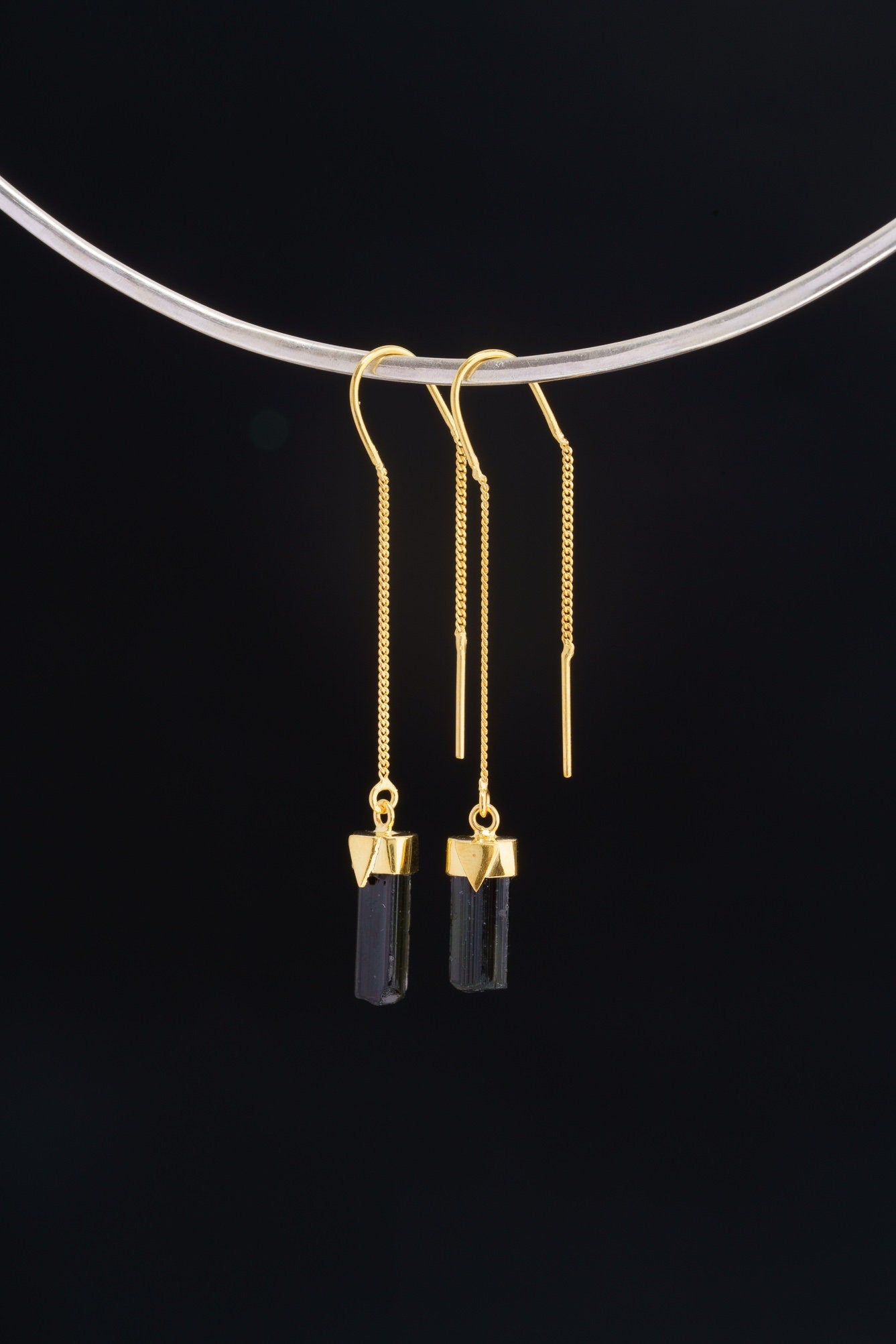Single gold-plated Tourmaline dangle earring displayed on a choker with slim black crystal and fine hook.