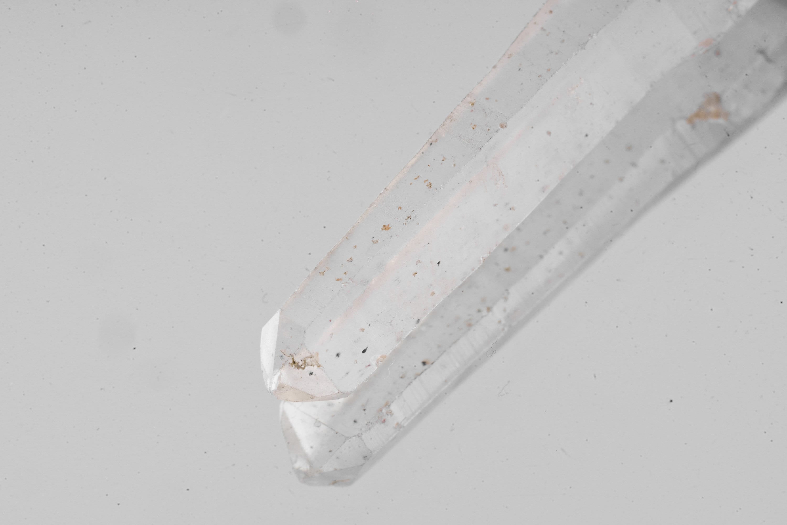 Macro detail of Australian Clear Quartz point showing natural surface markings, internal clarity, and crystal formation.