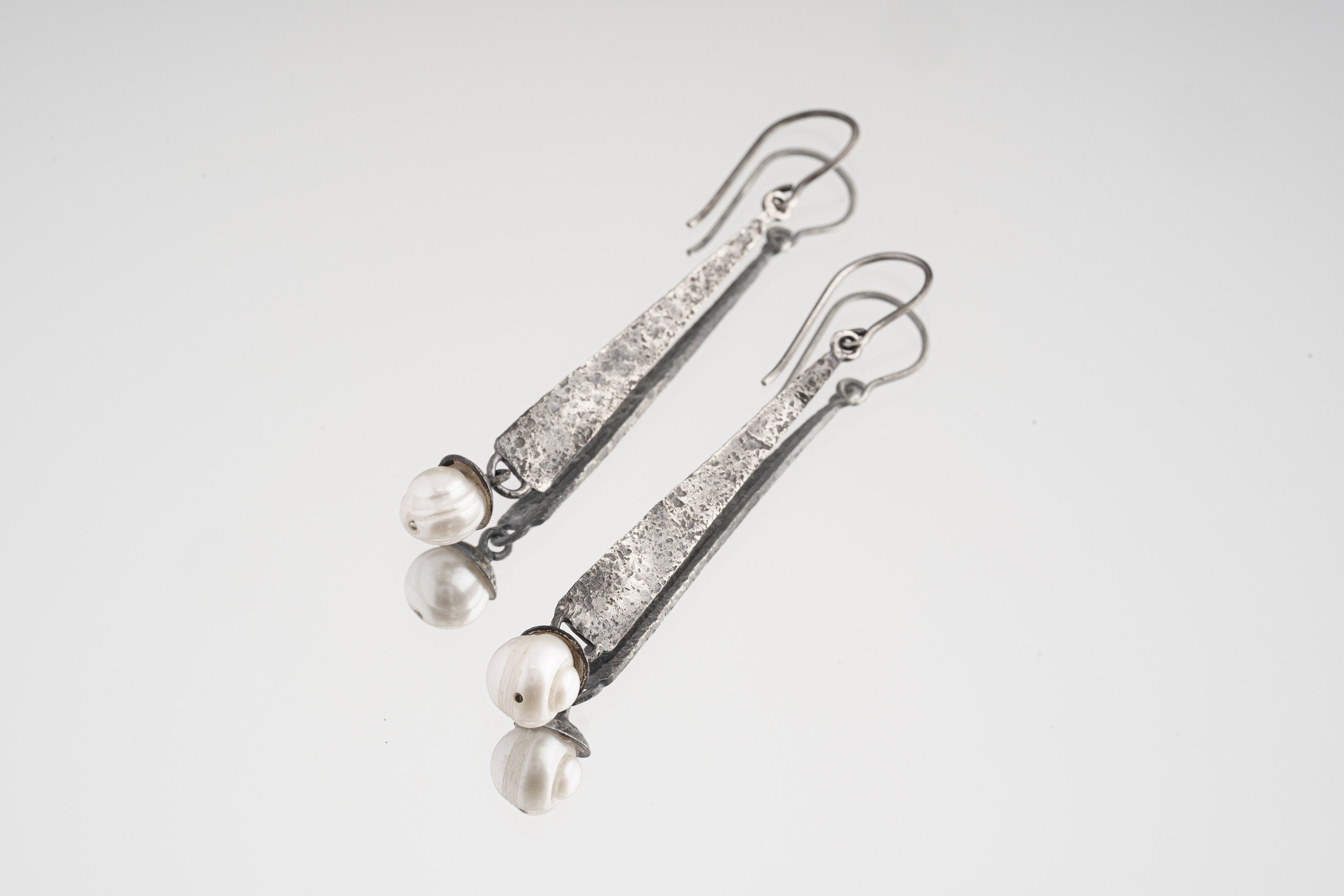 Rustic Pearl Triangle Gumnut single earring in textured 925 sterling silver shown on a light background.