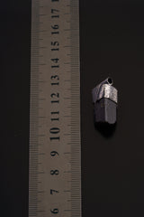 Himalayan Dravite Tourmaline Stack Pendant shown beside a ruler for scale with oxidized silver cap and dark crystal.